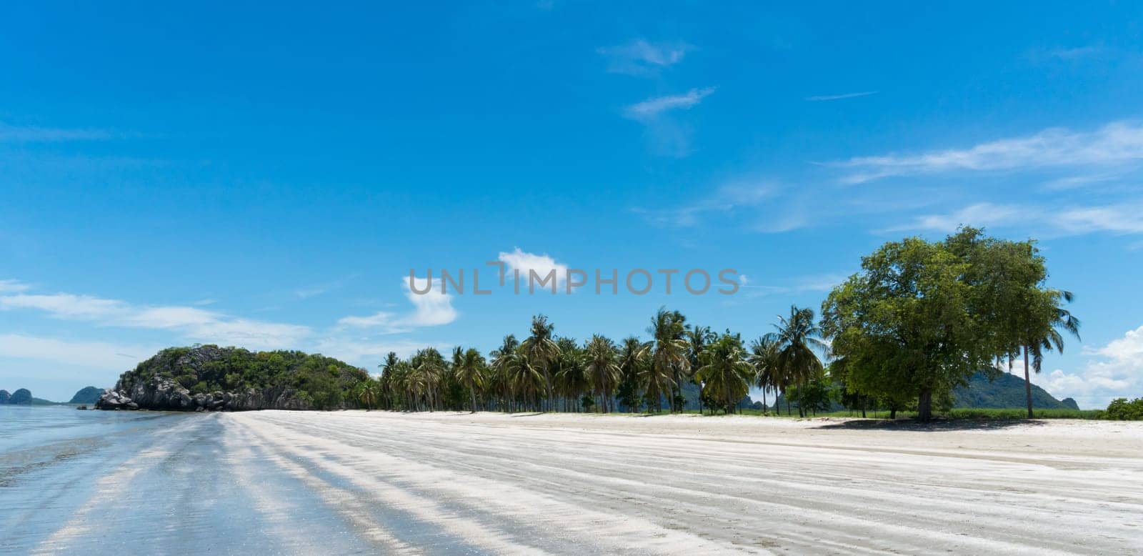 Green tree rock or stone mountain or hill and coconut tree at Sam Phraya Beach Prachuap Khiri Khan Thailand. Landscape or scenery in natural for summer .concept