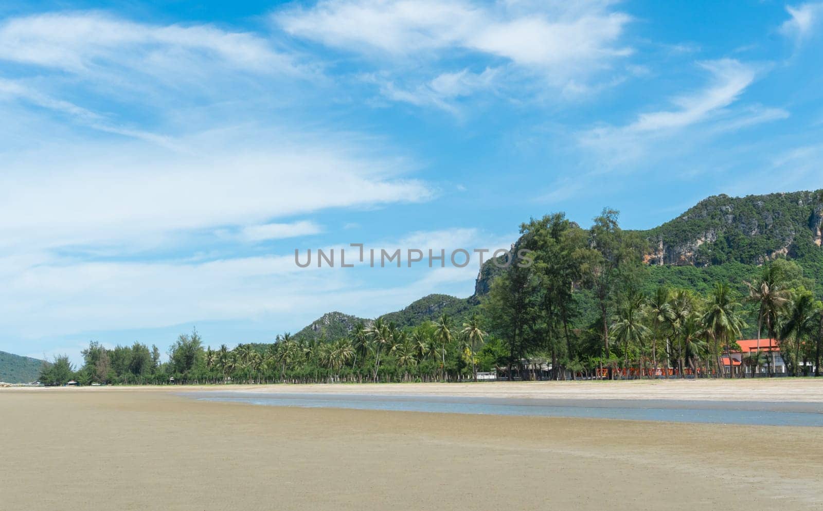 Green Rock or Stone Mountain or Hill and Coconut Tree at Sam Roi Yod Beach Prachuap Khiri Khan Thailand. Landscape or scenery for summer .season concept