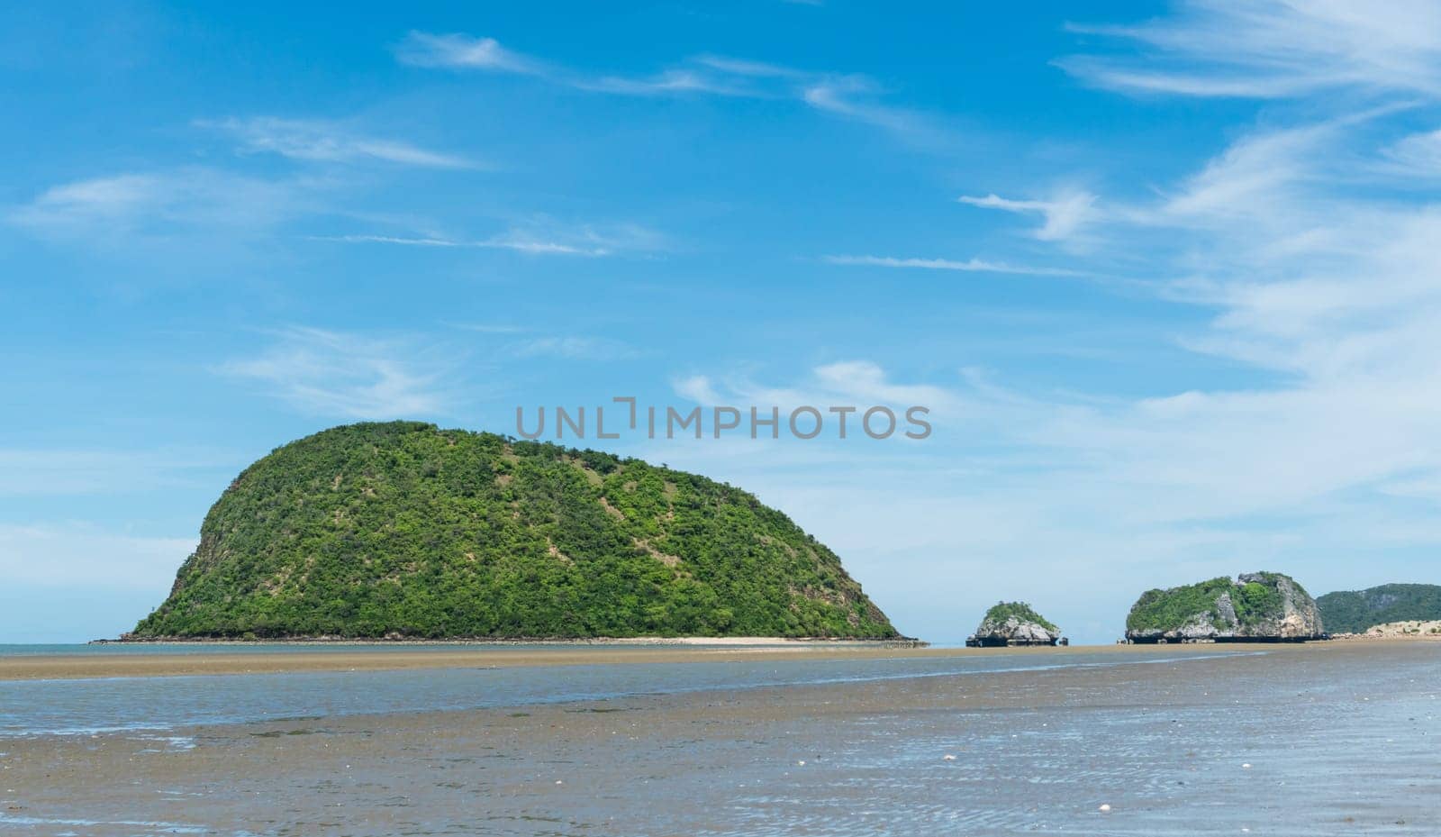 Ko Nom Sao at Sam Roi Yod Beach Prachuap Khiri Khan Thailand with blue sky and cloud. Rock or stone mountain or hill. Landscape or scenery for summer season concept