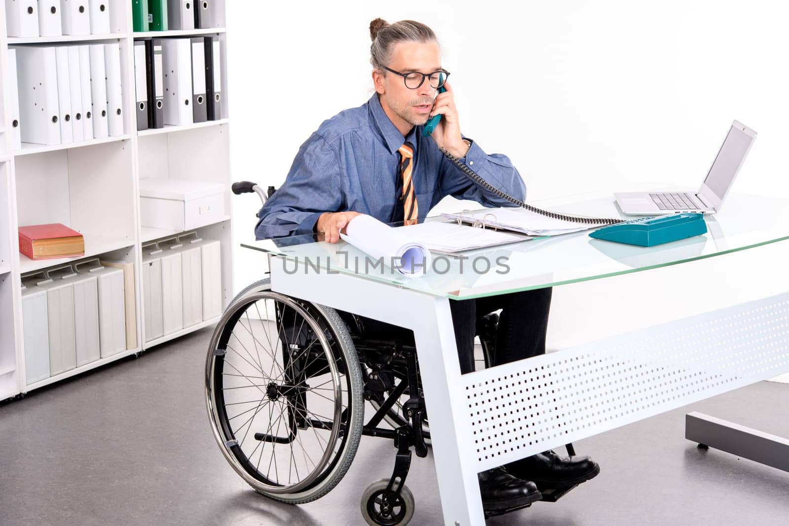 disabled business man in wheelchair working  in the office