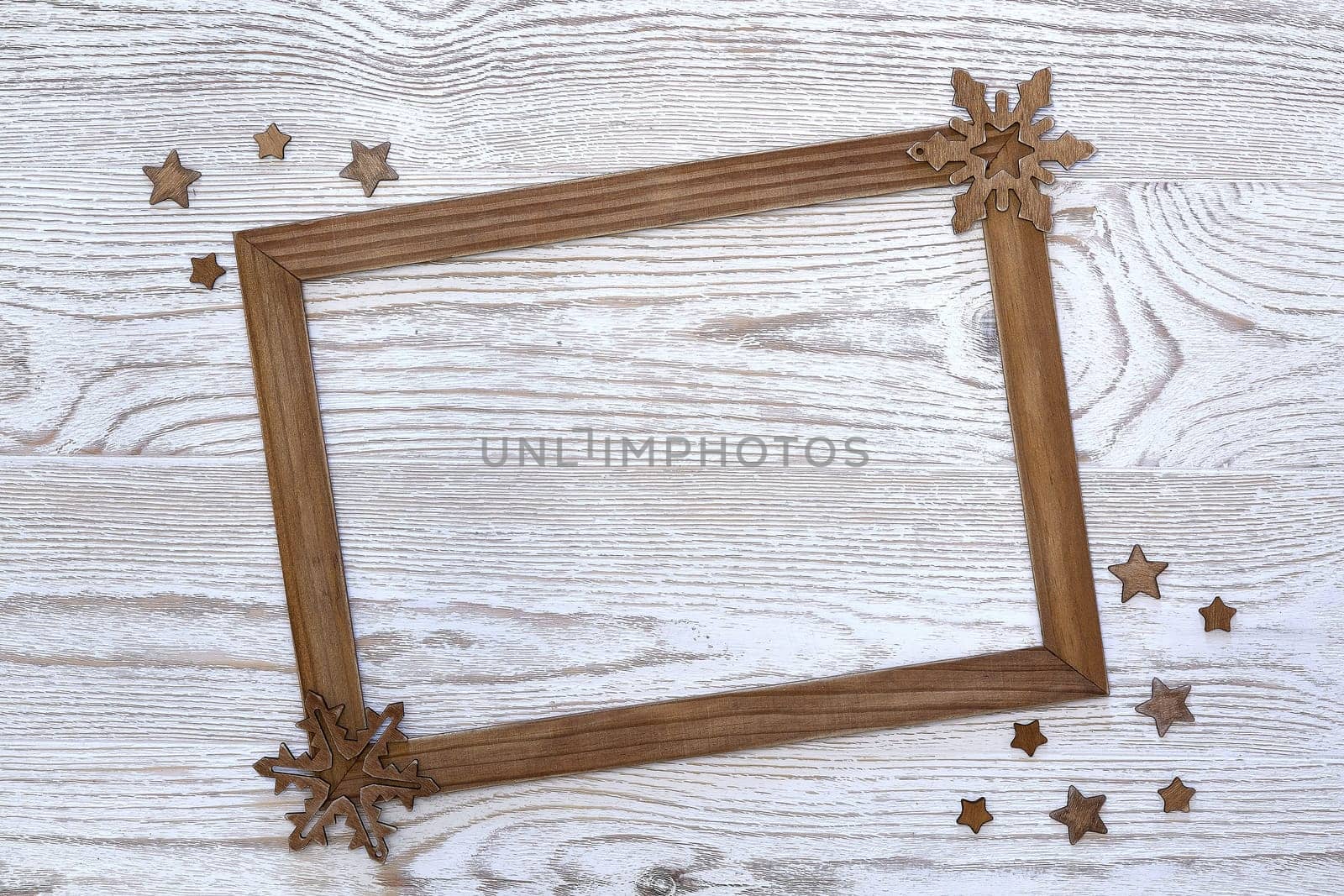 Christmas decorations with empty frame on a light wooden background with copy space for text. Top view. Christmas and New Year. Greeting card