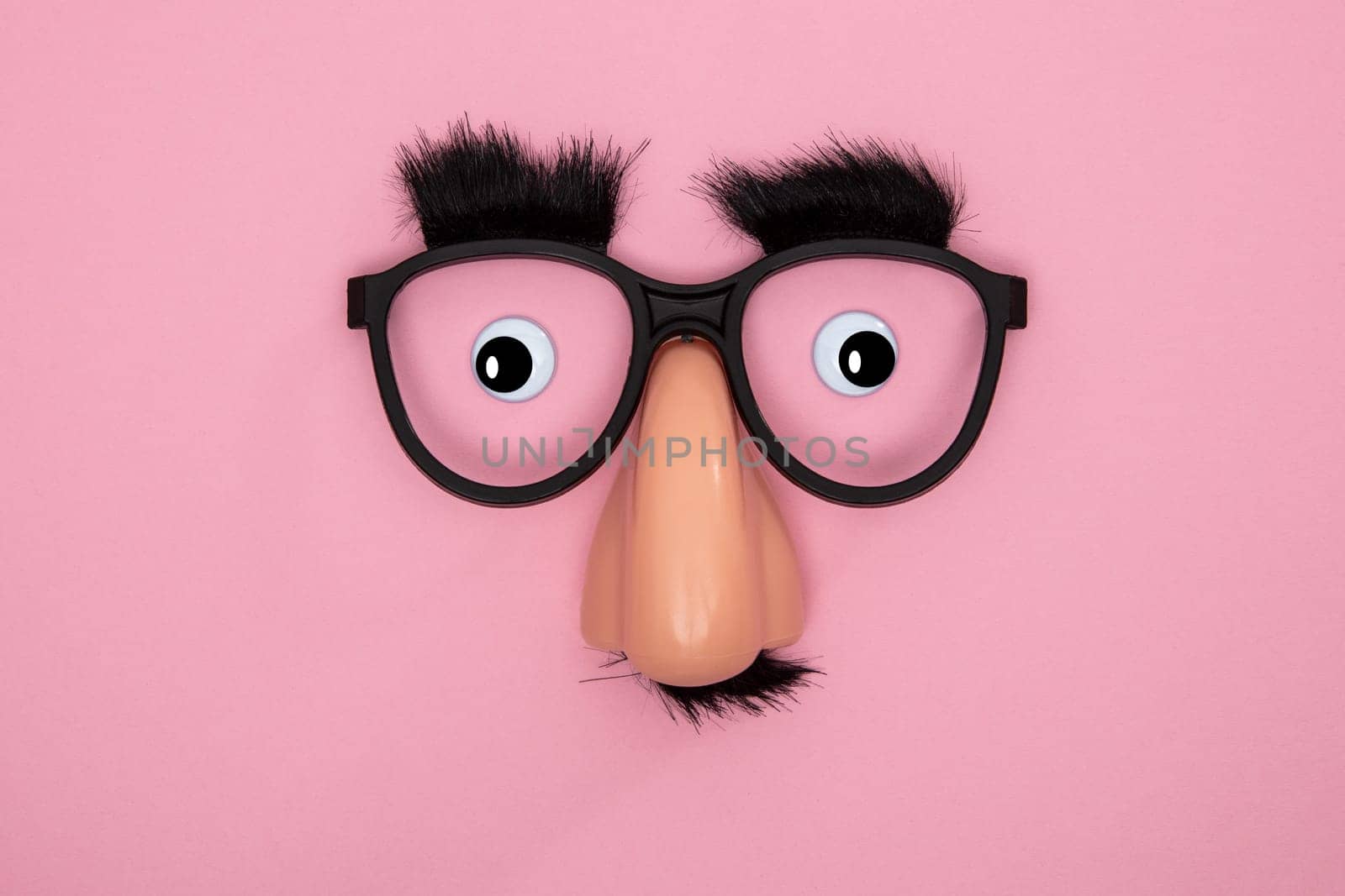 Funny Mask with Eyes and Nose on pink Background