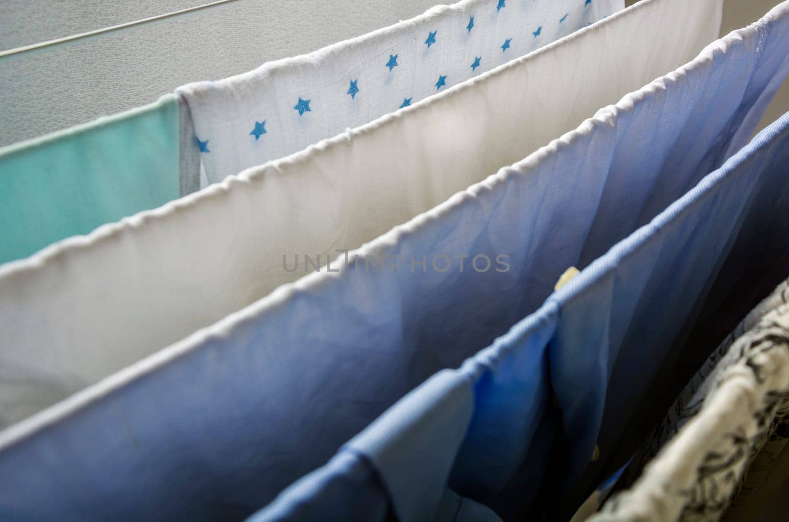 Laundry drying on a clotheshorse with star shaped decorated fabric in focus