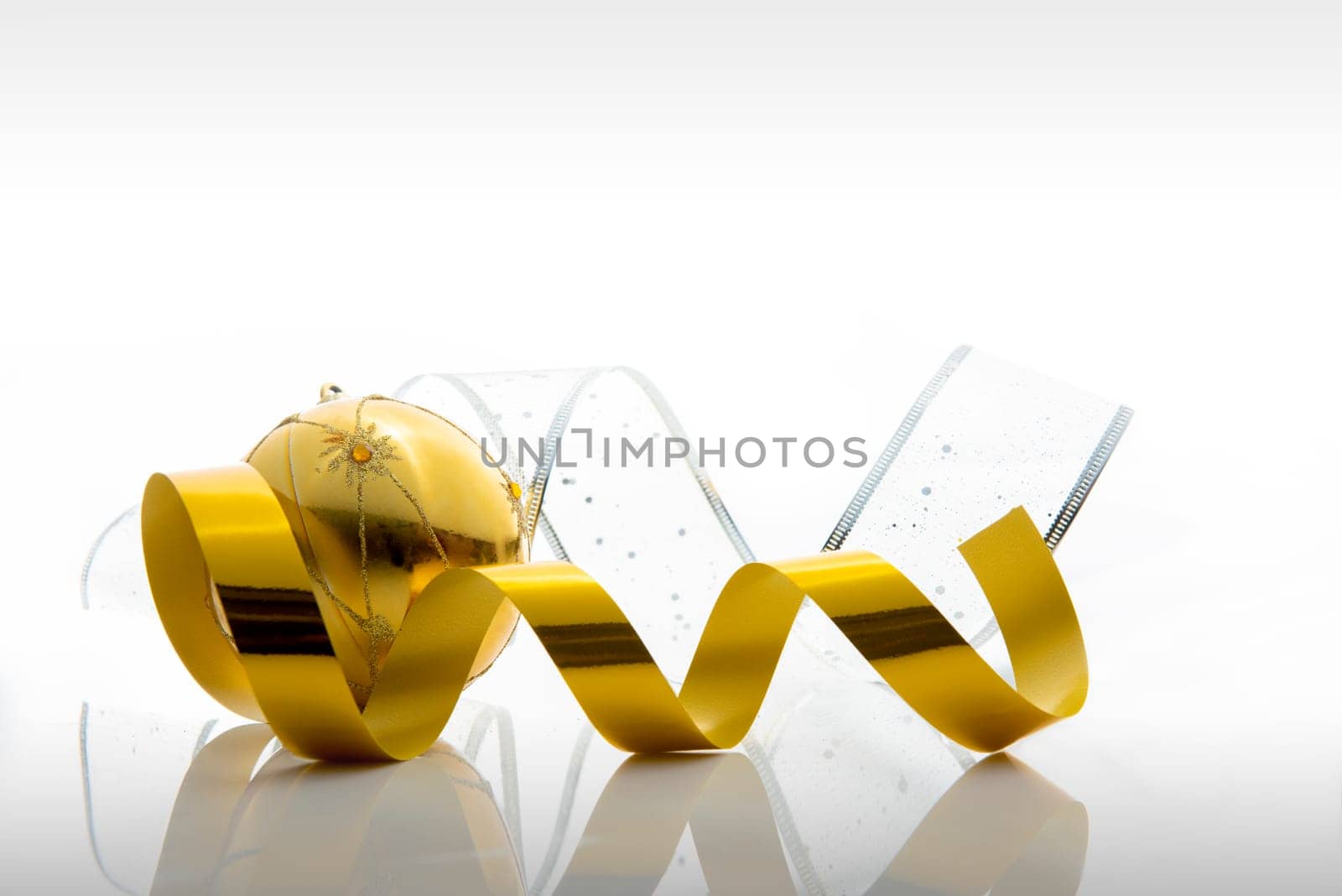 Ribbon and gold christmas ball. Christmas ornaments isolated over white background
