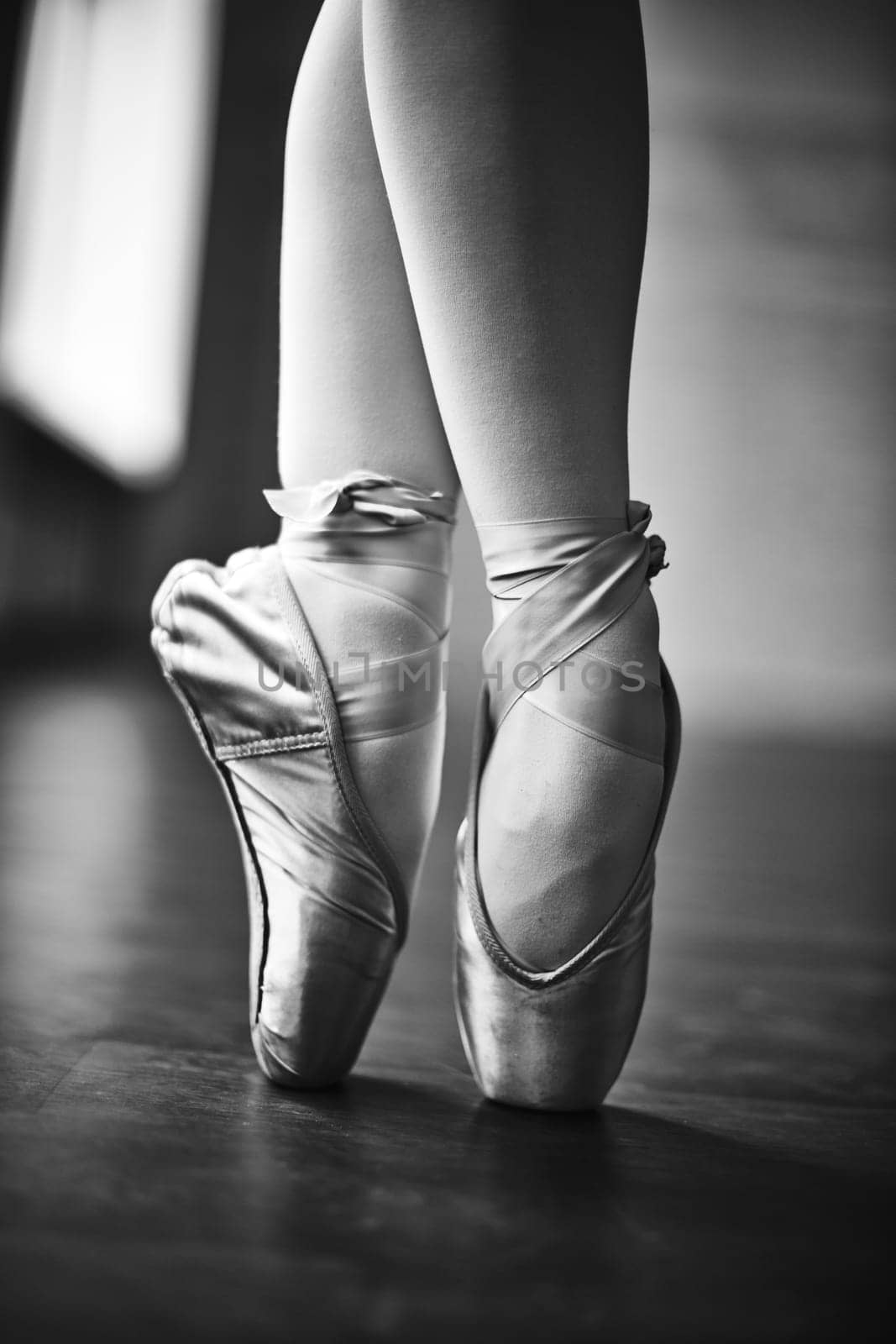 Feet of dancing girl in ballet shoes