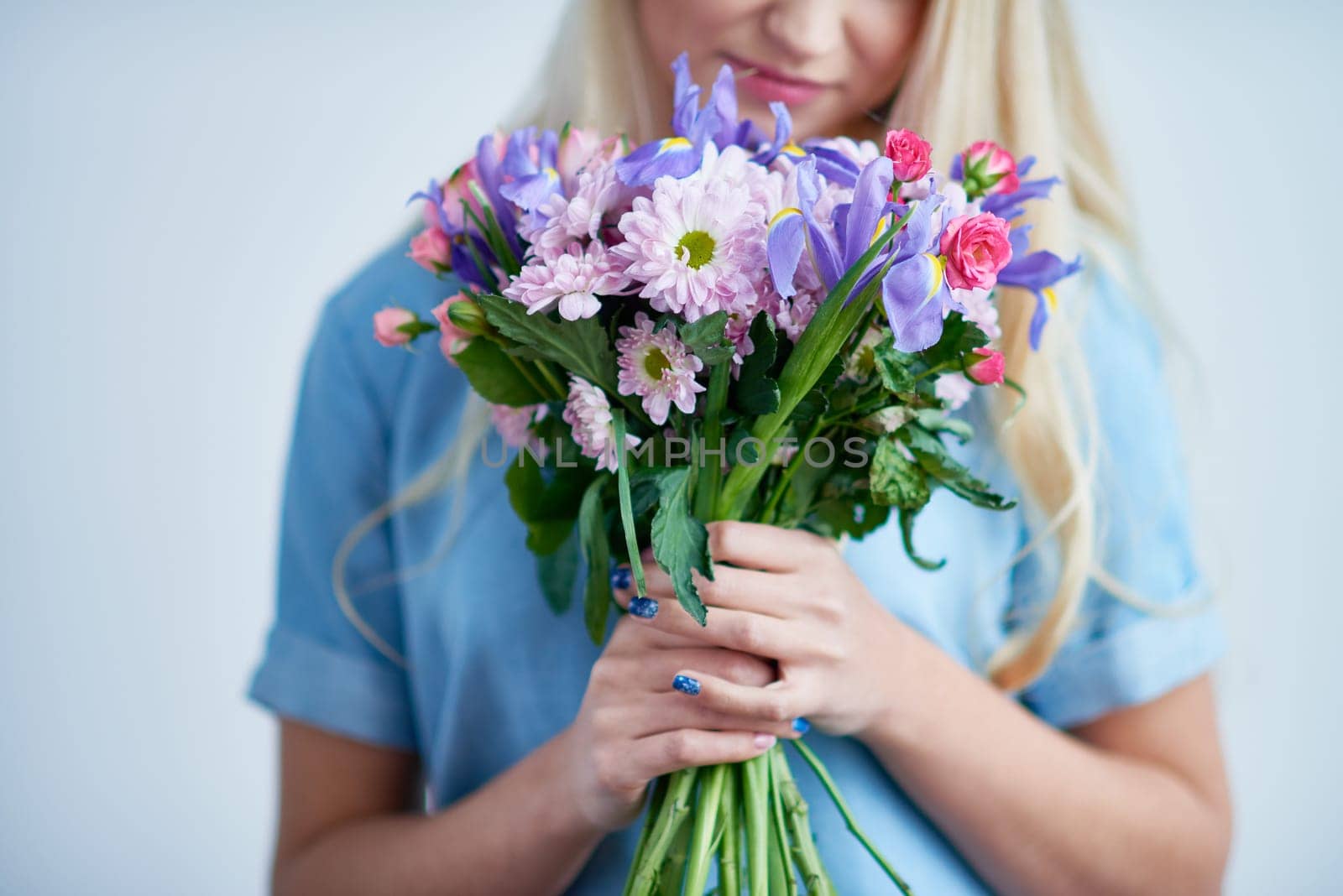 Young female smelling fresh floral bouquet