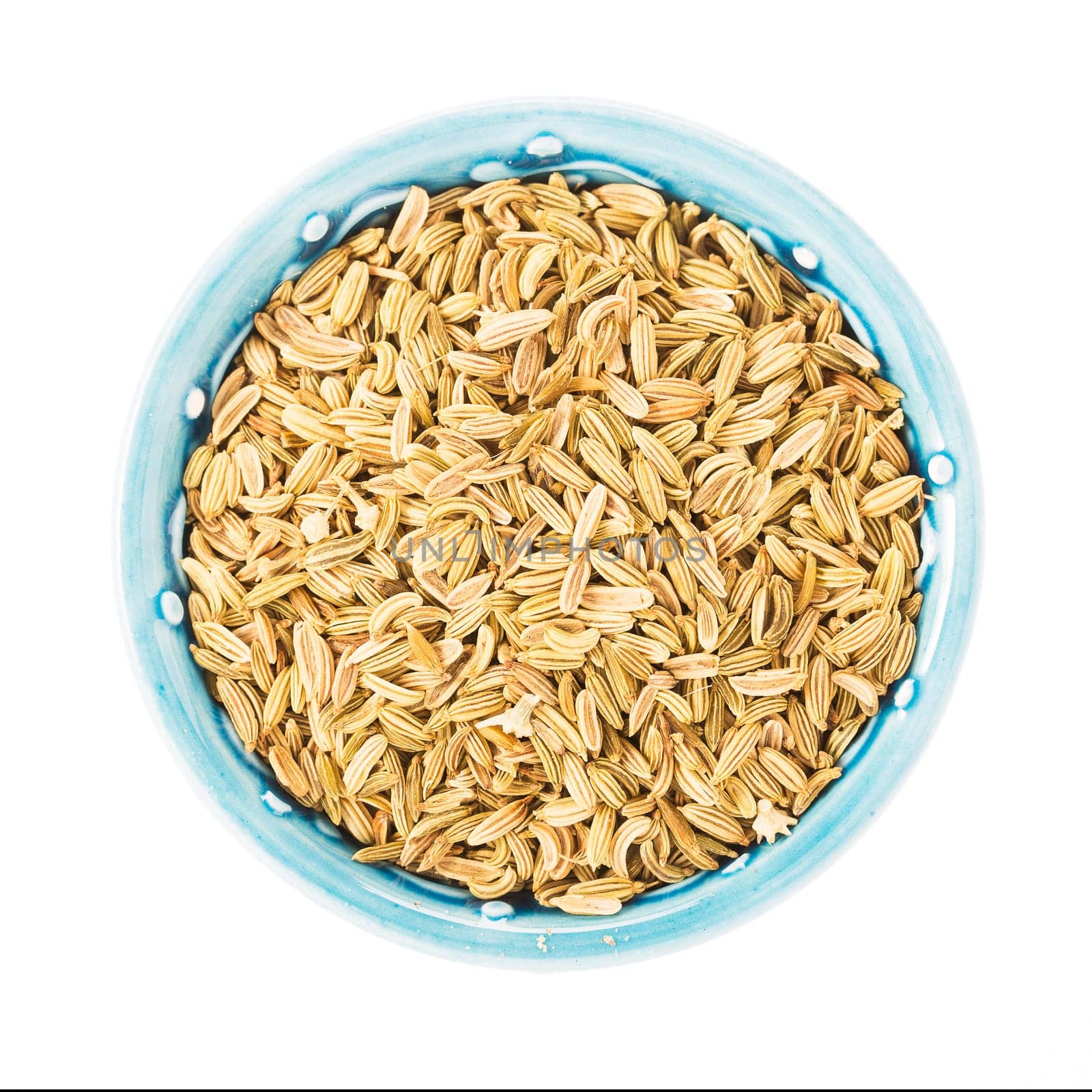 Fennel seeds in bowl isolated on white background.