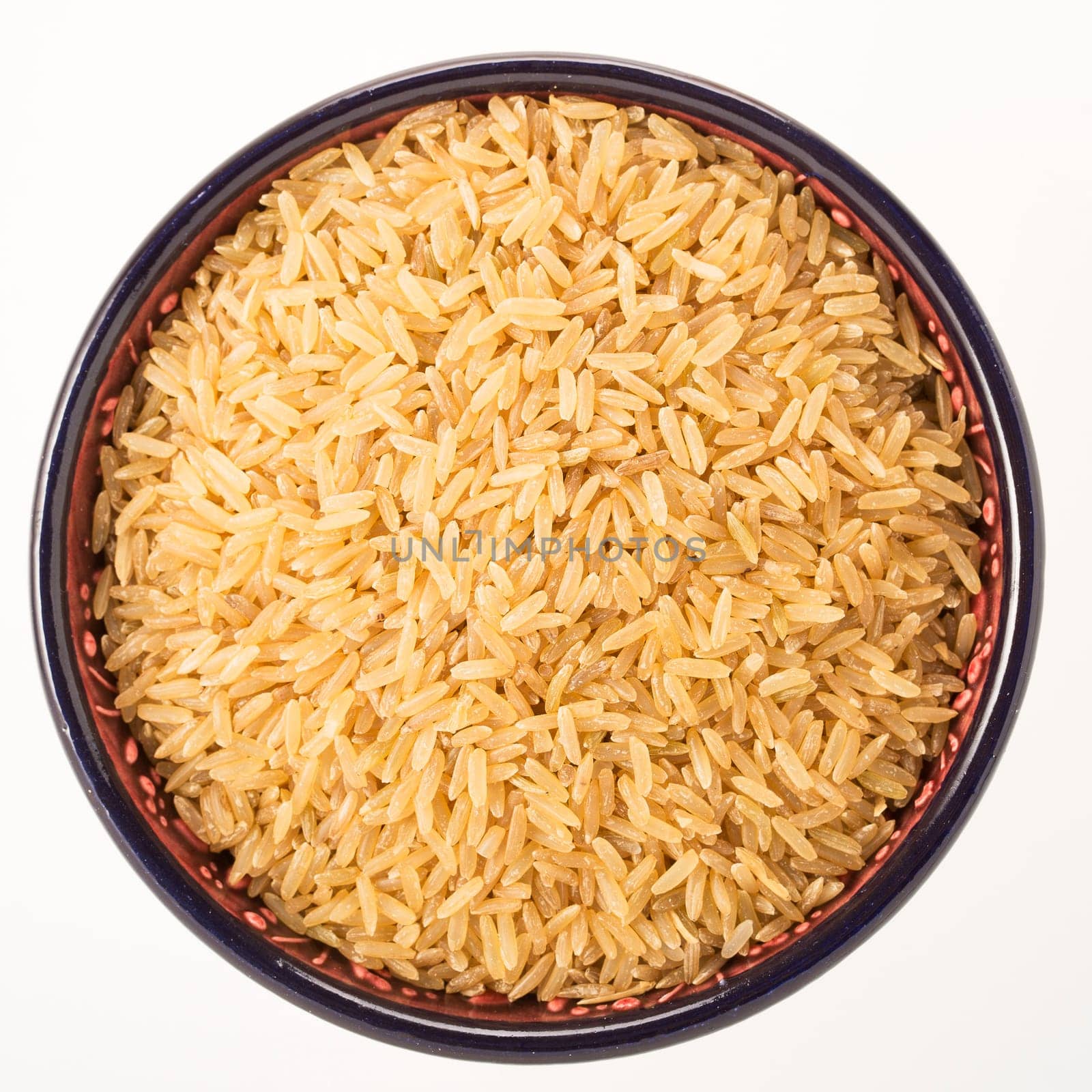 Brown rice in bowl isolated on white background
