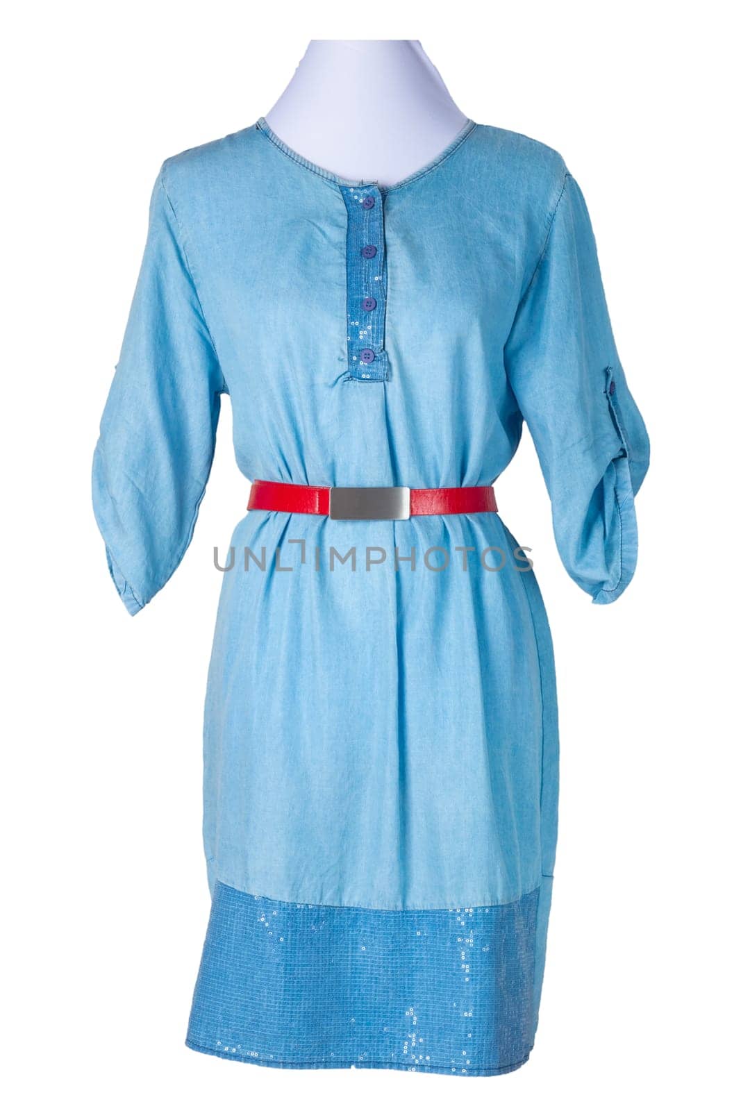 Woman spring summer dress. women's blue jeans denim dress with a red belt on a mannequin isolated on a white background. Jeans fashion. Party and cocktail dresses.
