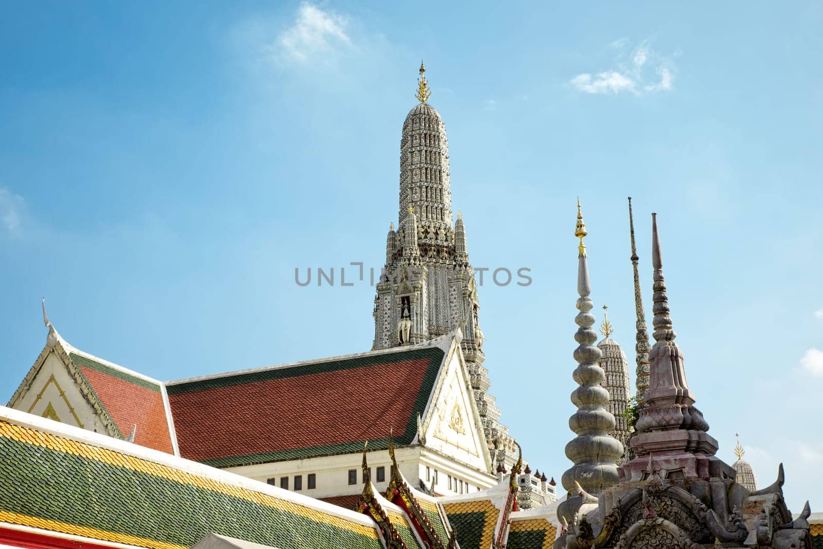 Architectural detail from exterior view of the Buddhist temple, Wat Arun over blue sky in Bangkok, Thailand