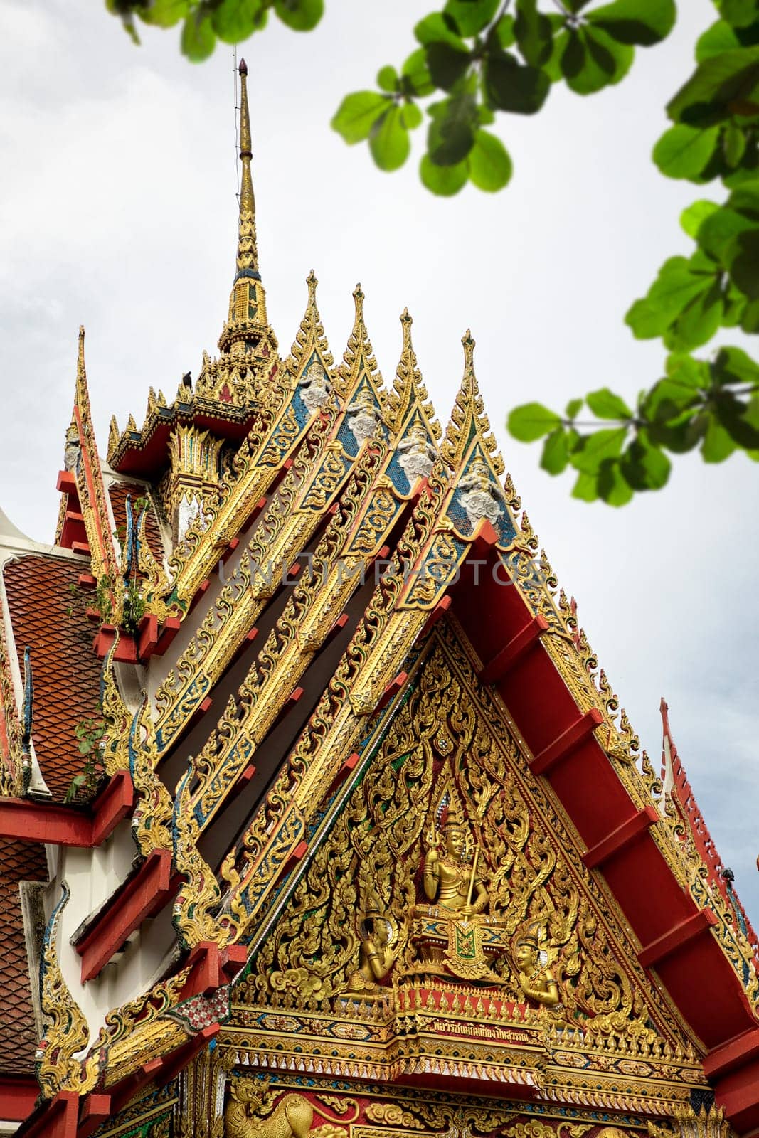 Architectural detail from exterior view of the Buddhist temple in Damnoen Saduak Floating Market near Bangkok, Thailand .