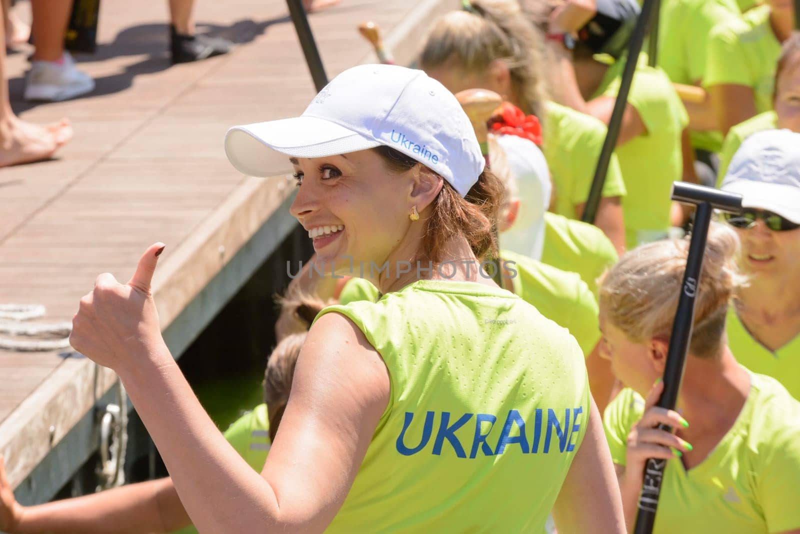 Rome, Italy - July 30, 2016: Dragon boat crews  compete at the european championships held in Italy in 2016 summer, ukrainian girl smiling and tumb up after the race