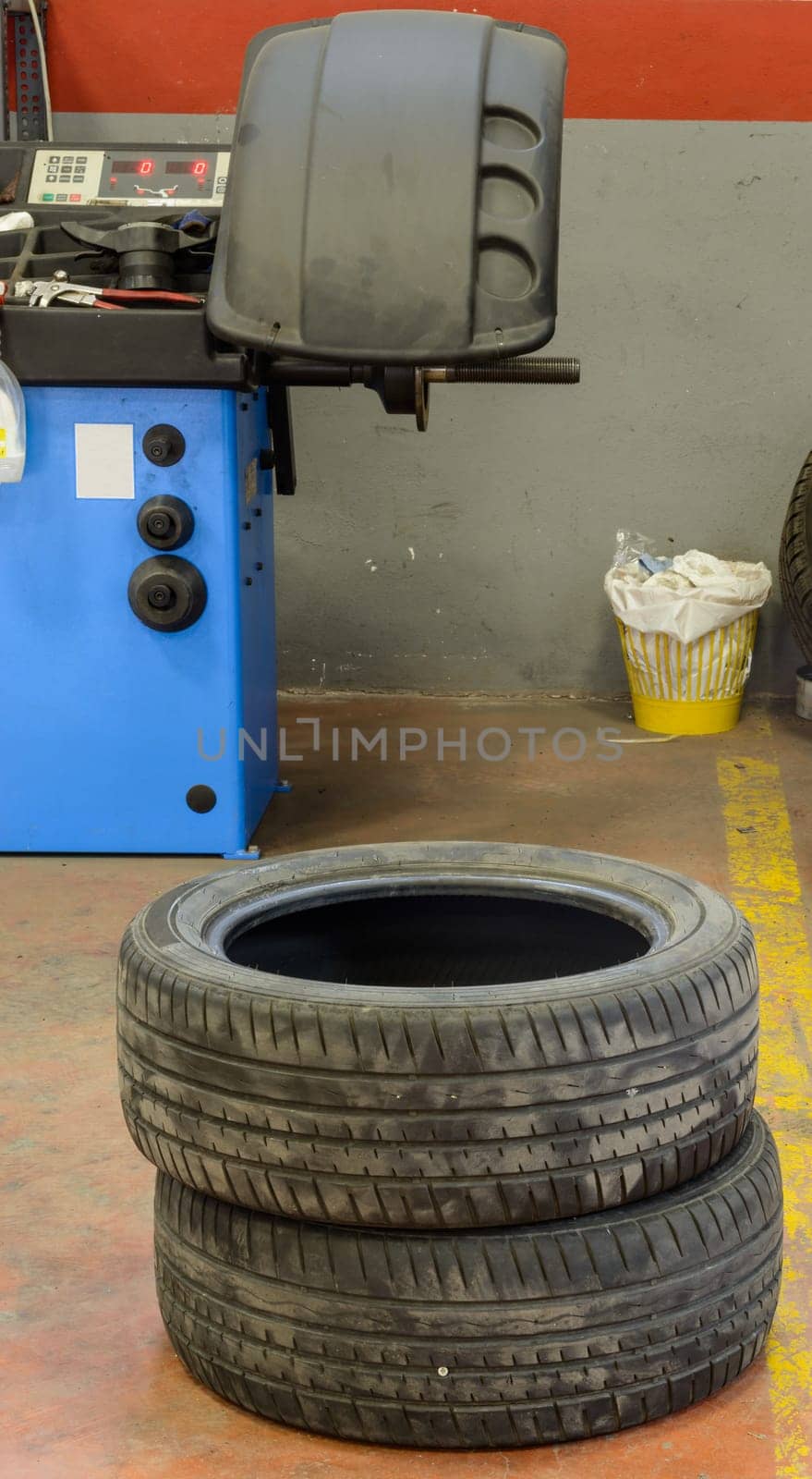 Various tools and stuff in a tire fix  workshop and a diplay of balancing machine