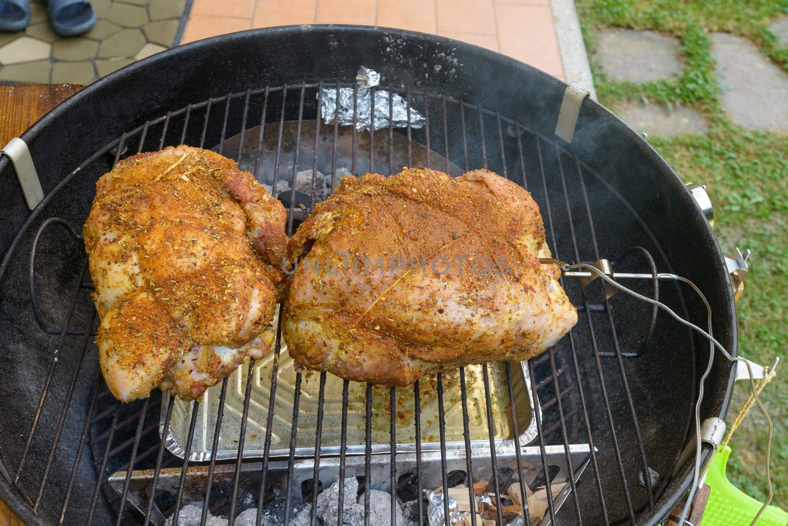 Pulled pork cooking and grilling inside a barbecue