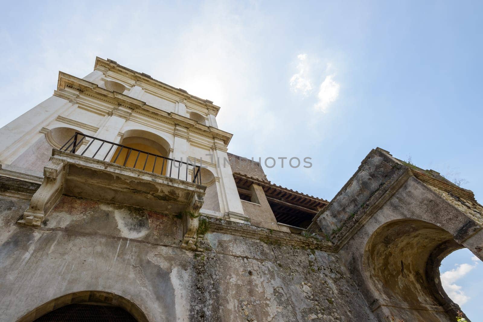 An ancient and old building from the bottom, in background a nice blue sky