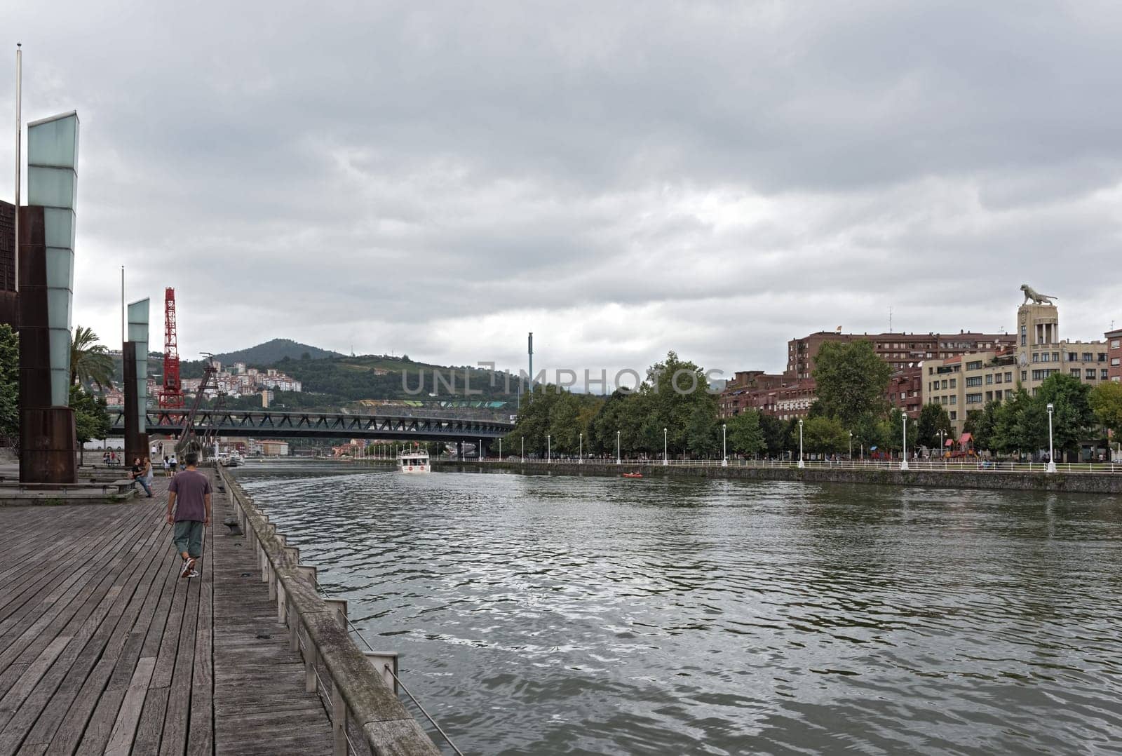 bilbao downtown with nervion river and boardwalk area, basque country, spain.