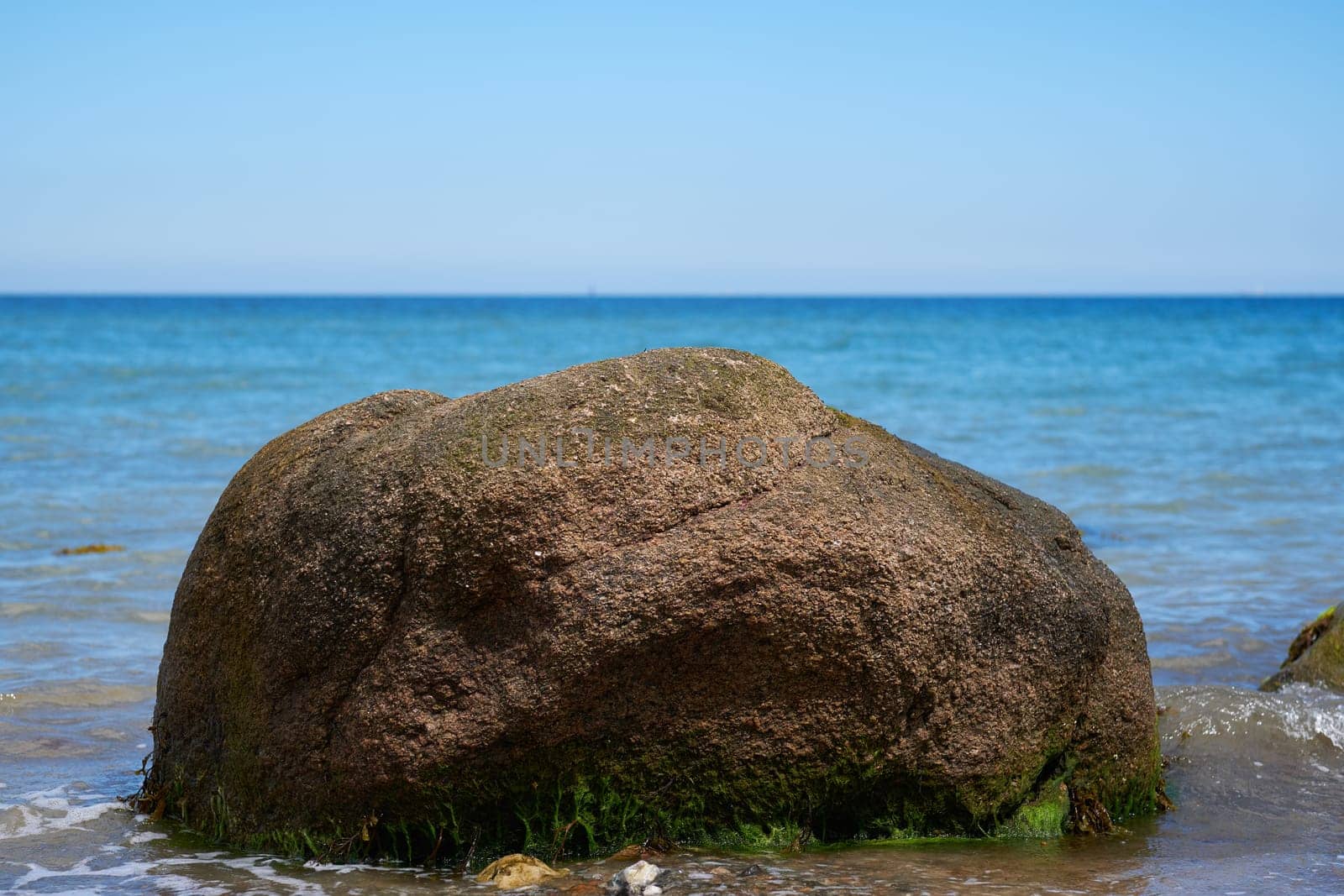 Erratic block in the surf - Baltic Sea in Schleswig-Holstein - Germany - detailed shot
