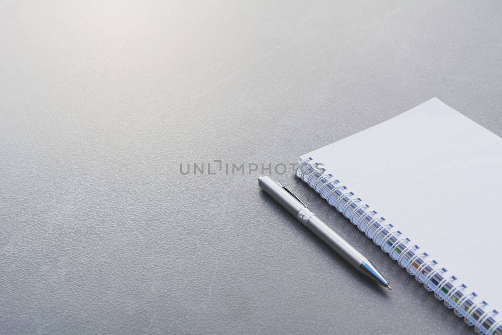 White blank notebook, textbook and pen on table with copy space.