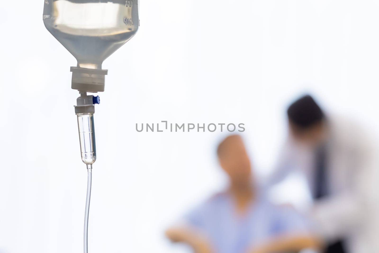 Set iv fluid intravenous drop saline drip in hospital room with patient and doctor in background