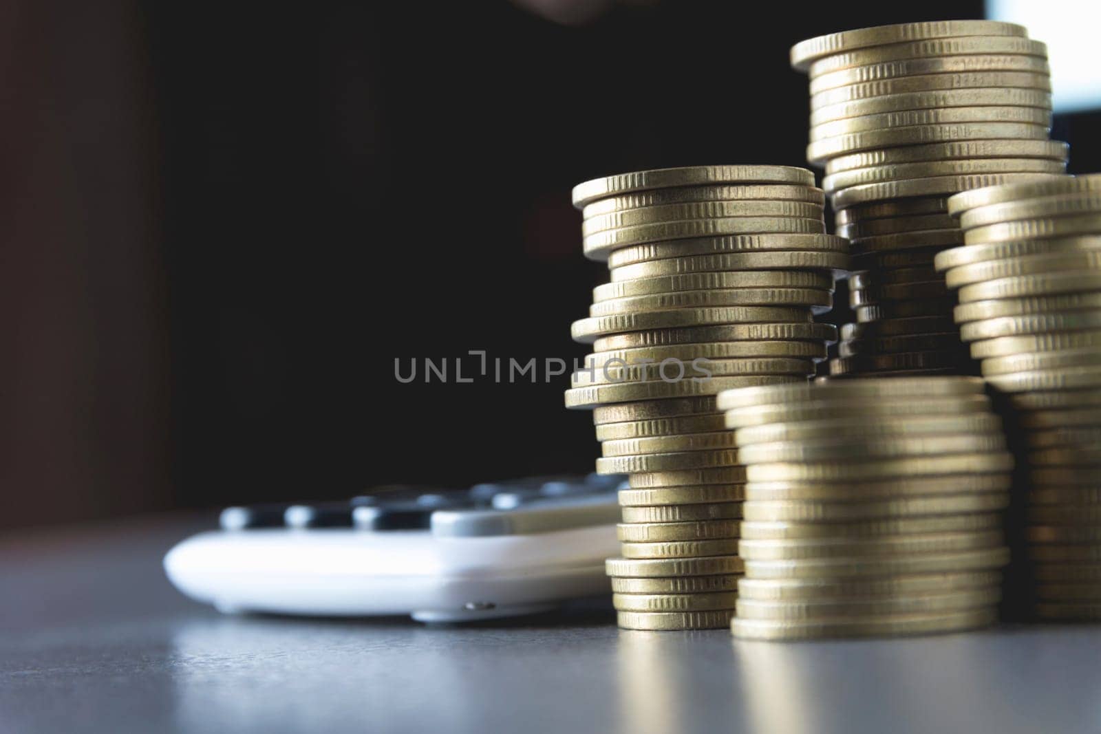 Saving money concept with money coin stack growing and calculator for business and accounting concept.