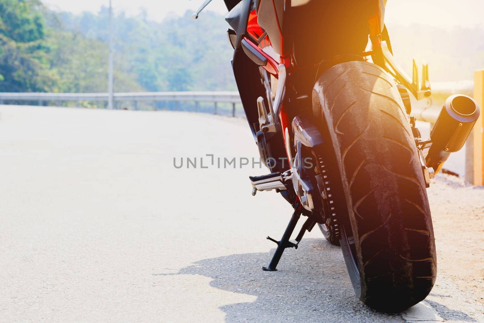 A motorcycle parking on the road right side and copy space for text.