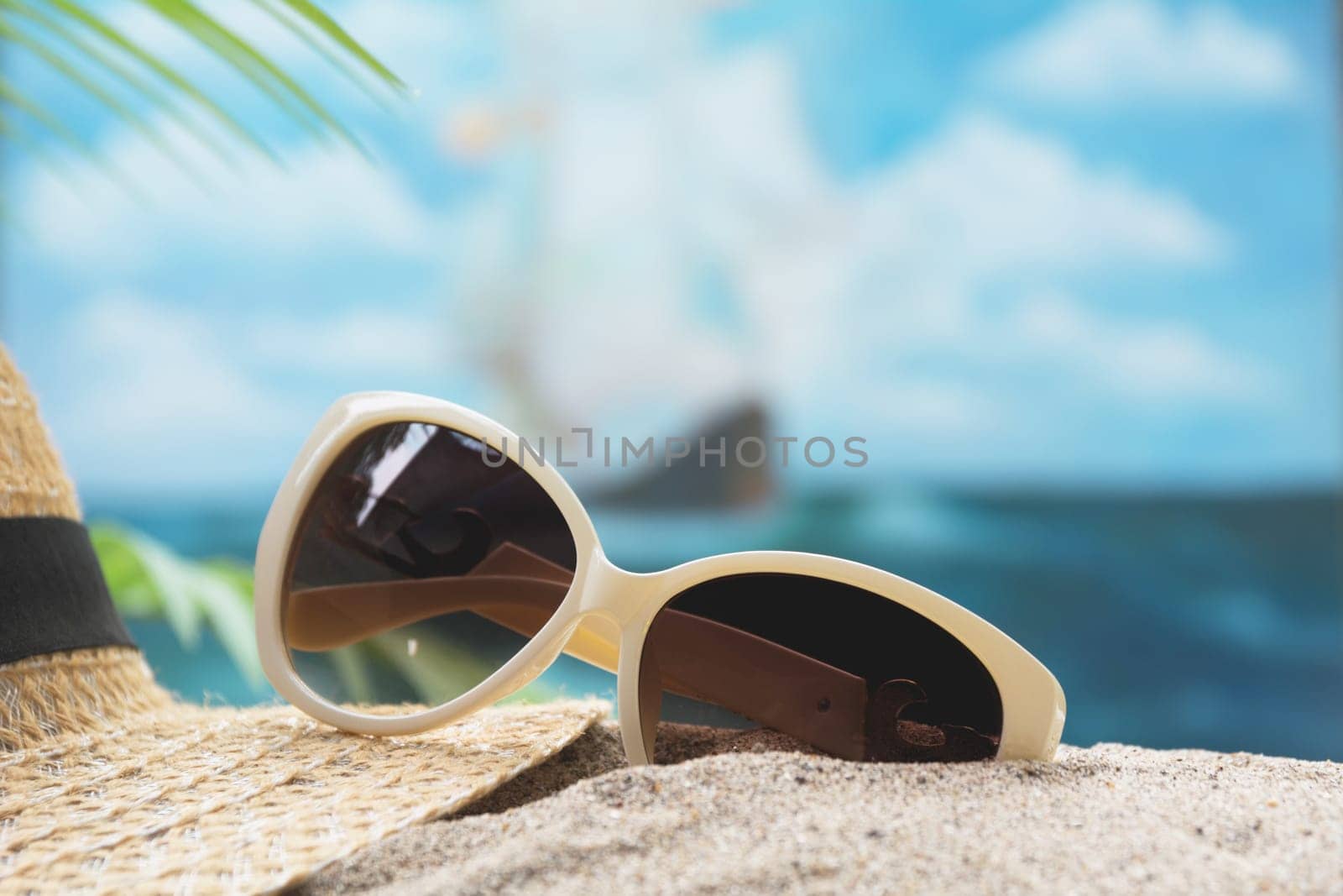 Travel equipment, eyeglasses and sun hat on sea and sky background. Copy space for creative design text and word.