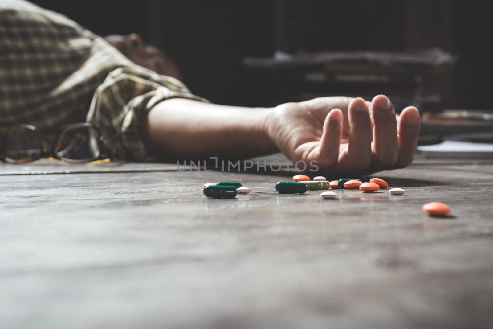 The man committing suicide by overdosing on medication. Close up of overdose pills and addict.
