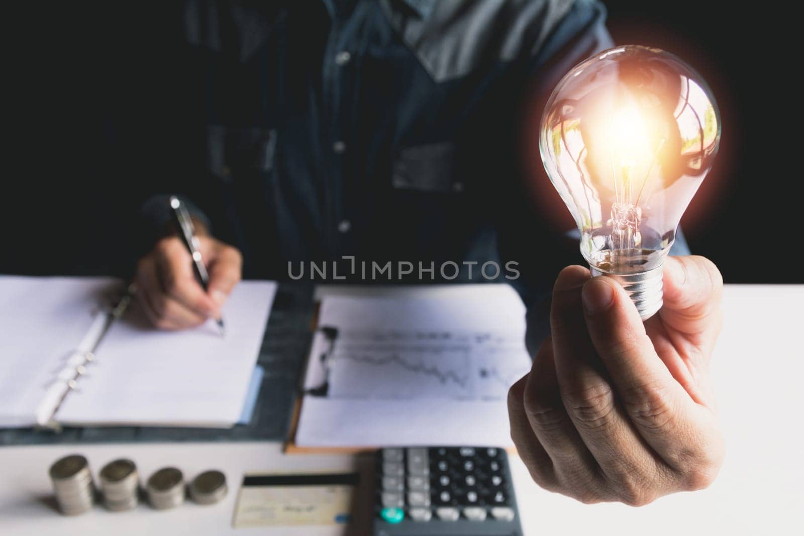 Hand of male holding a light bulb for innovation and creative concept .