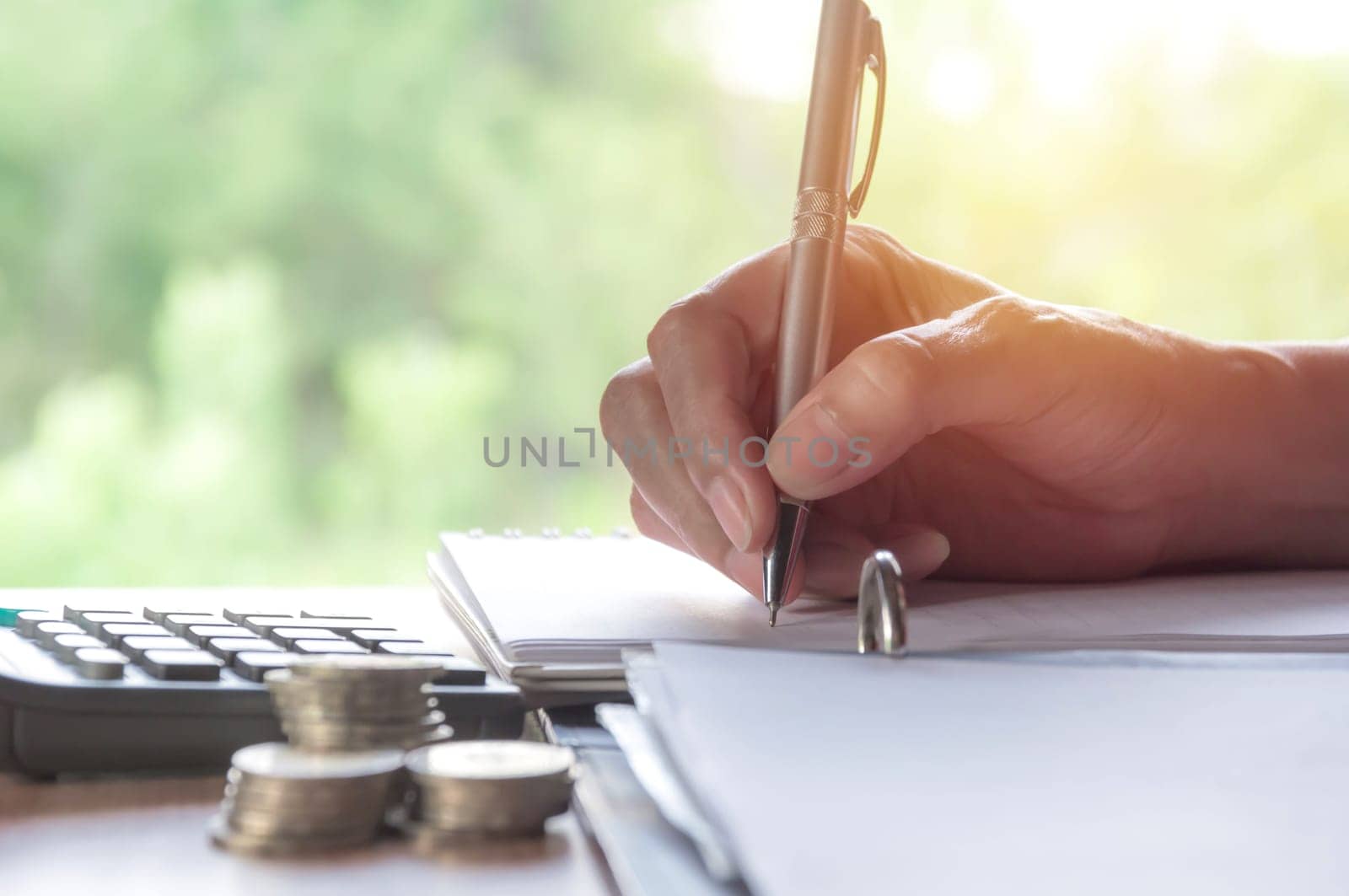 Man writing with stock financial indices with stack coin. Financial stock market in accounting market economy analysis.