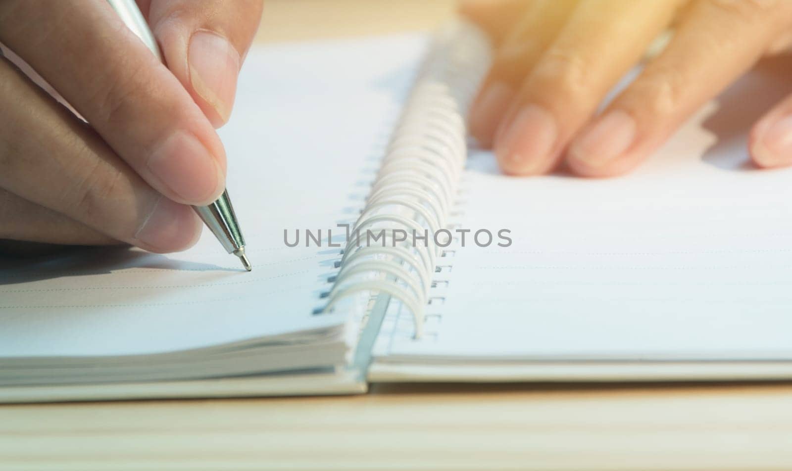 Close up hand writing on paper. Close up people writing on paper.