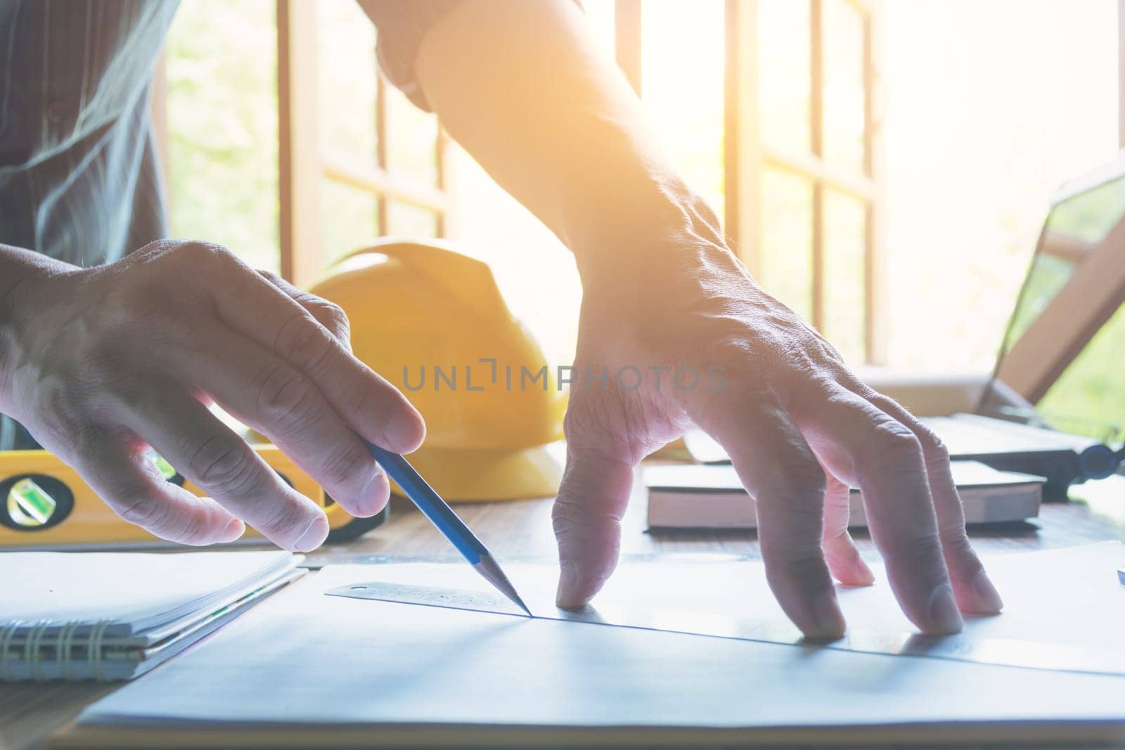 Architect engineer working concept and construction tools or safety equipment on table.