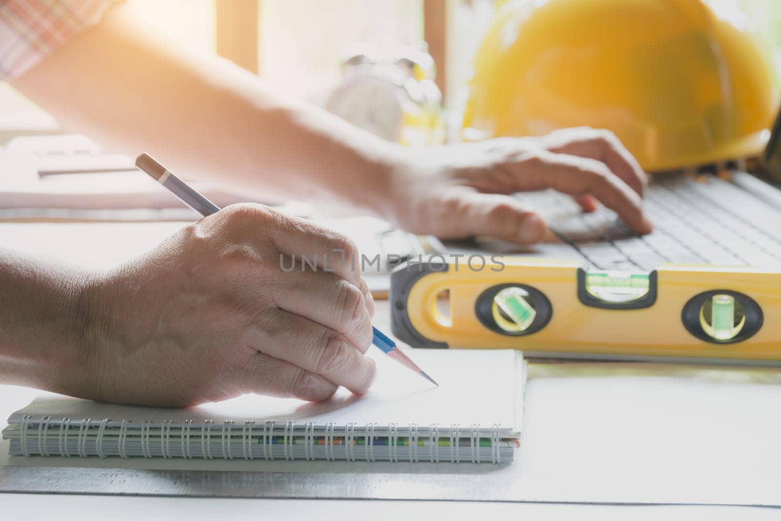 Architect engineer working concept and construction tools or safety equipment on table.