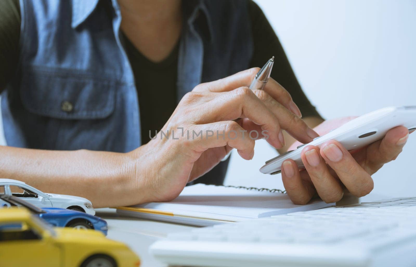 Car insurance and car service. Businesswoman and toy car, business and financial concept.
