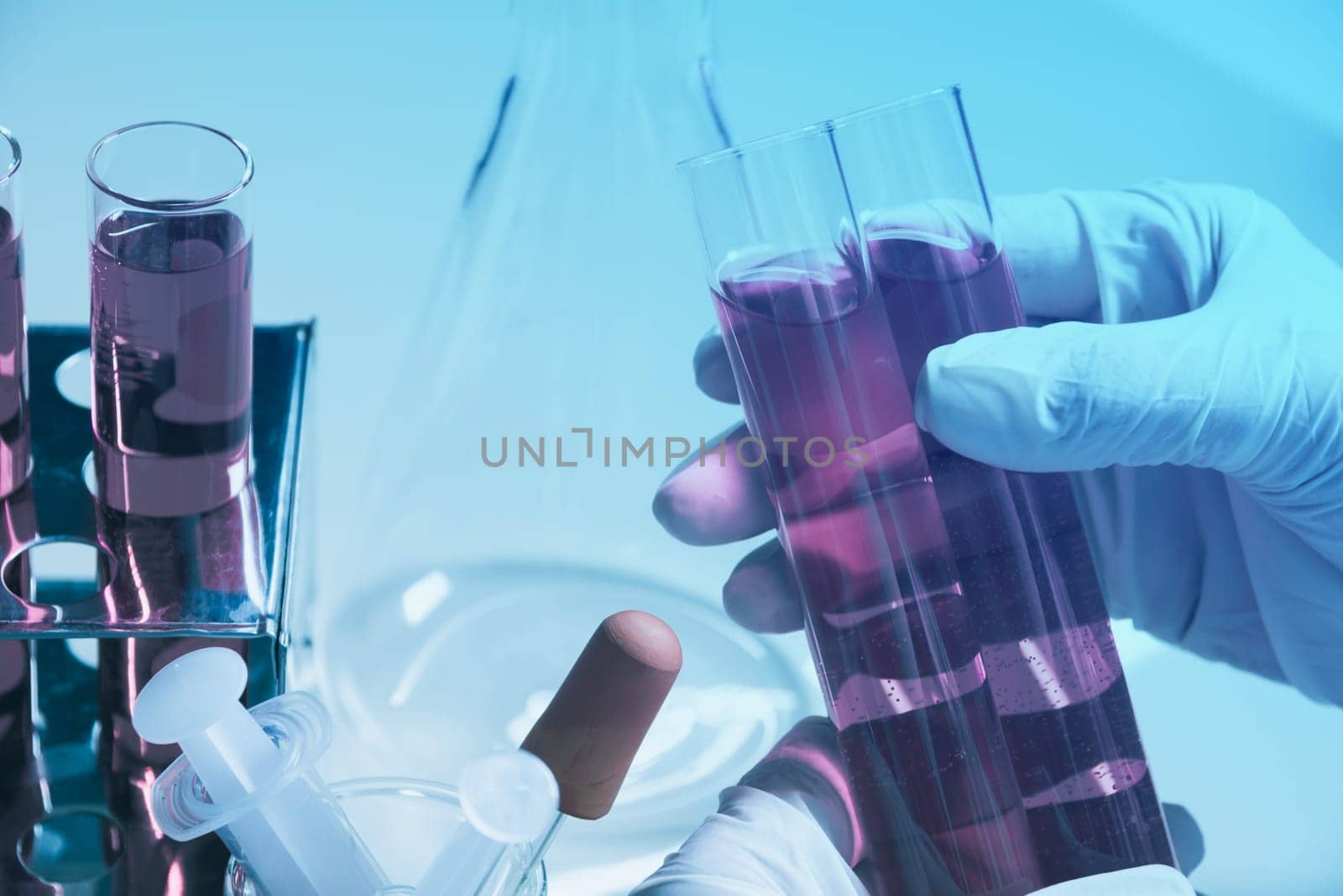 Researcher with glass laboratory chemical test tubes with liquid for analytical , medical, pharmaceutical and scientific research concept.