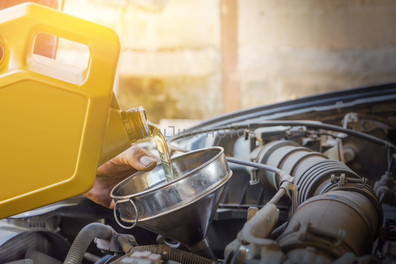 Technician checking engine and refueling. Auto mechanic checking car engine. Maintenance checking car.