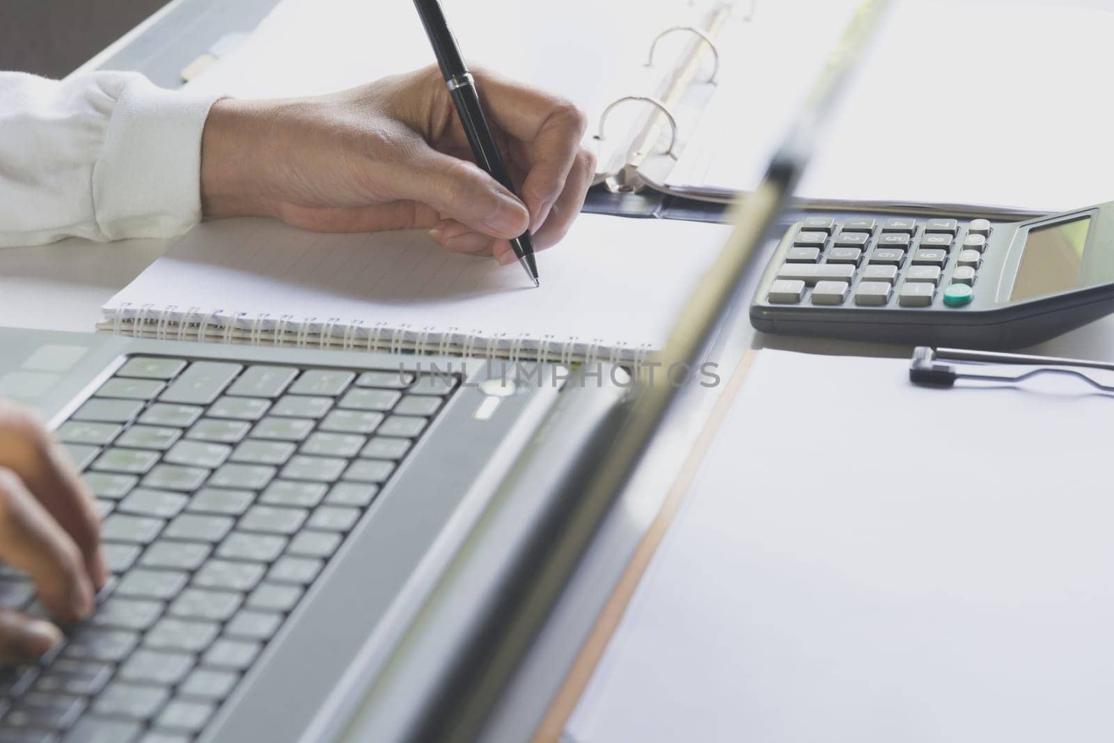 Person working and using a laptop for business and accounting concept.