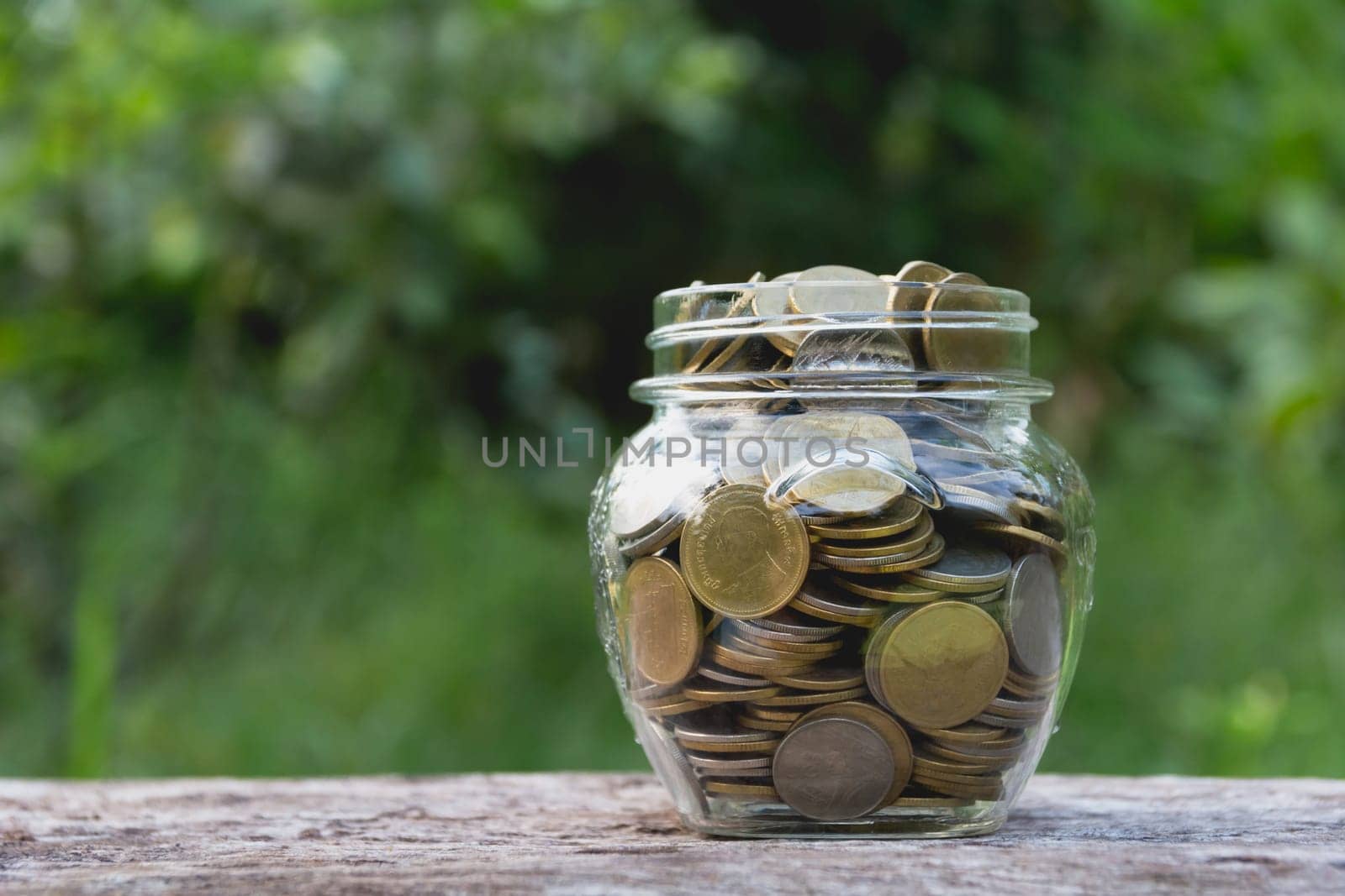 Saving money concept with money coin in glass jar for financial and accounting. financial and accounting concept.