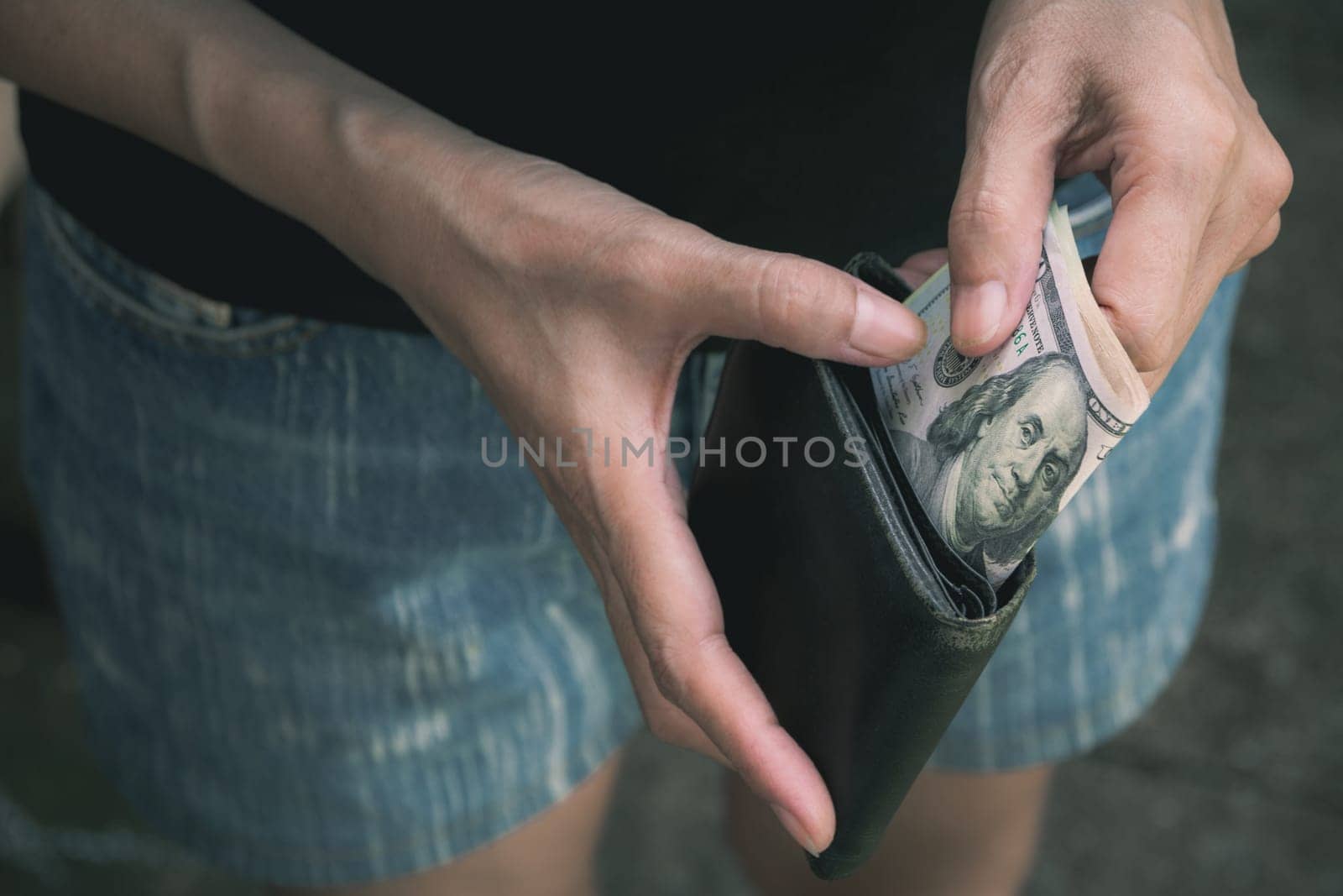 Hand holding a banknote in wallet for financial, accounting and saving money concept.