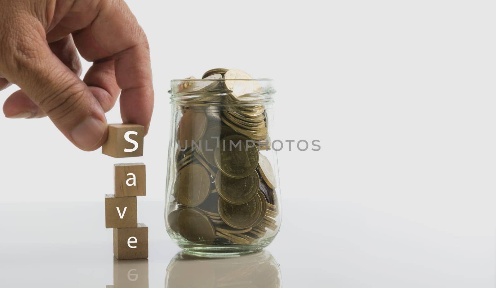 Text save on dice with coins and copy space for insert text on white background. Accounting and financial concept.