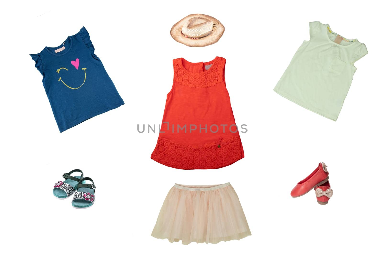 Set or collage of little girl clothes for day of the child. Colorful fashion for party or birthday party. Isolated on white. Close up. Decorated with a straw hat.