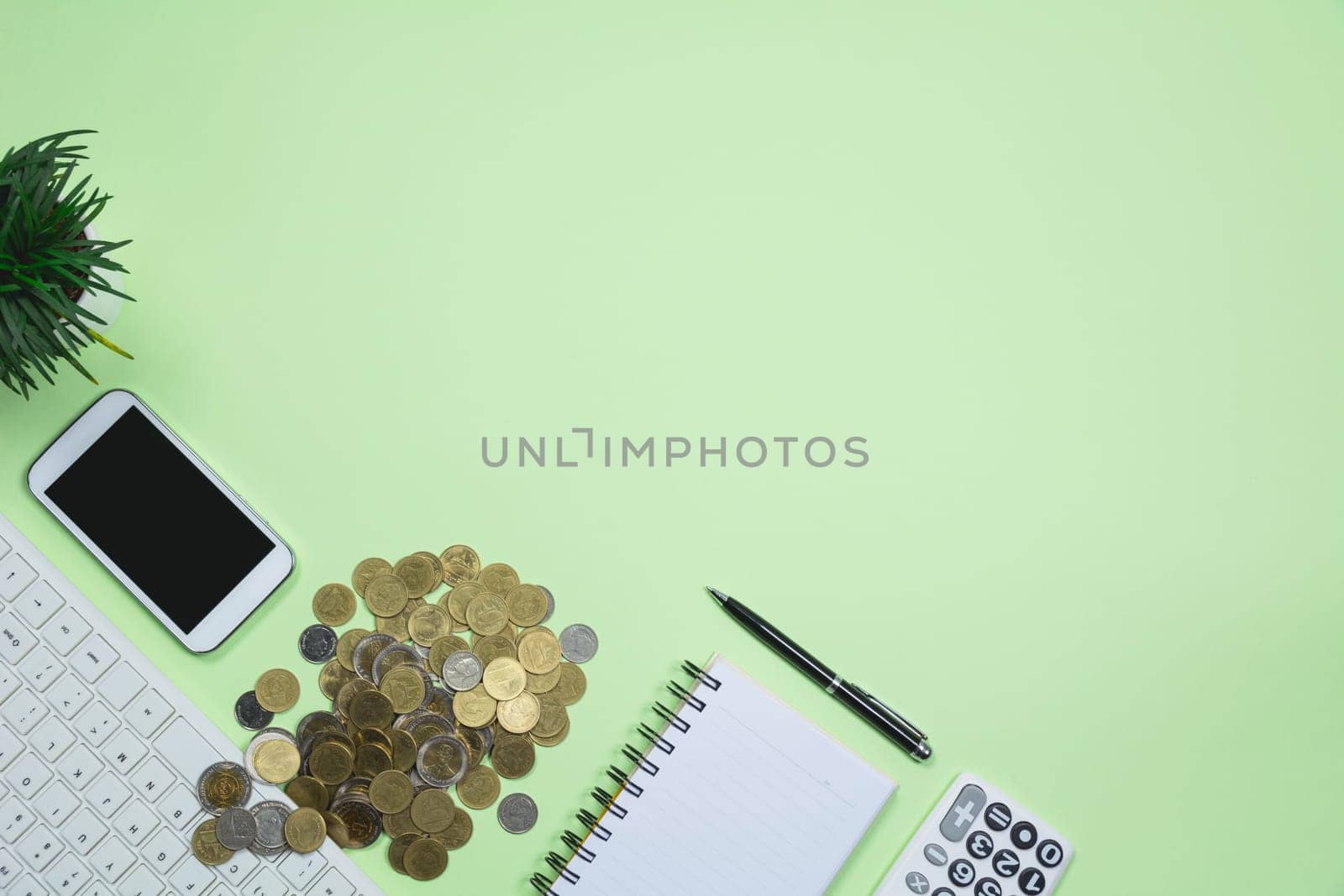 The office supplies on green background with copy space for insert text.