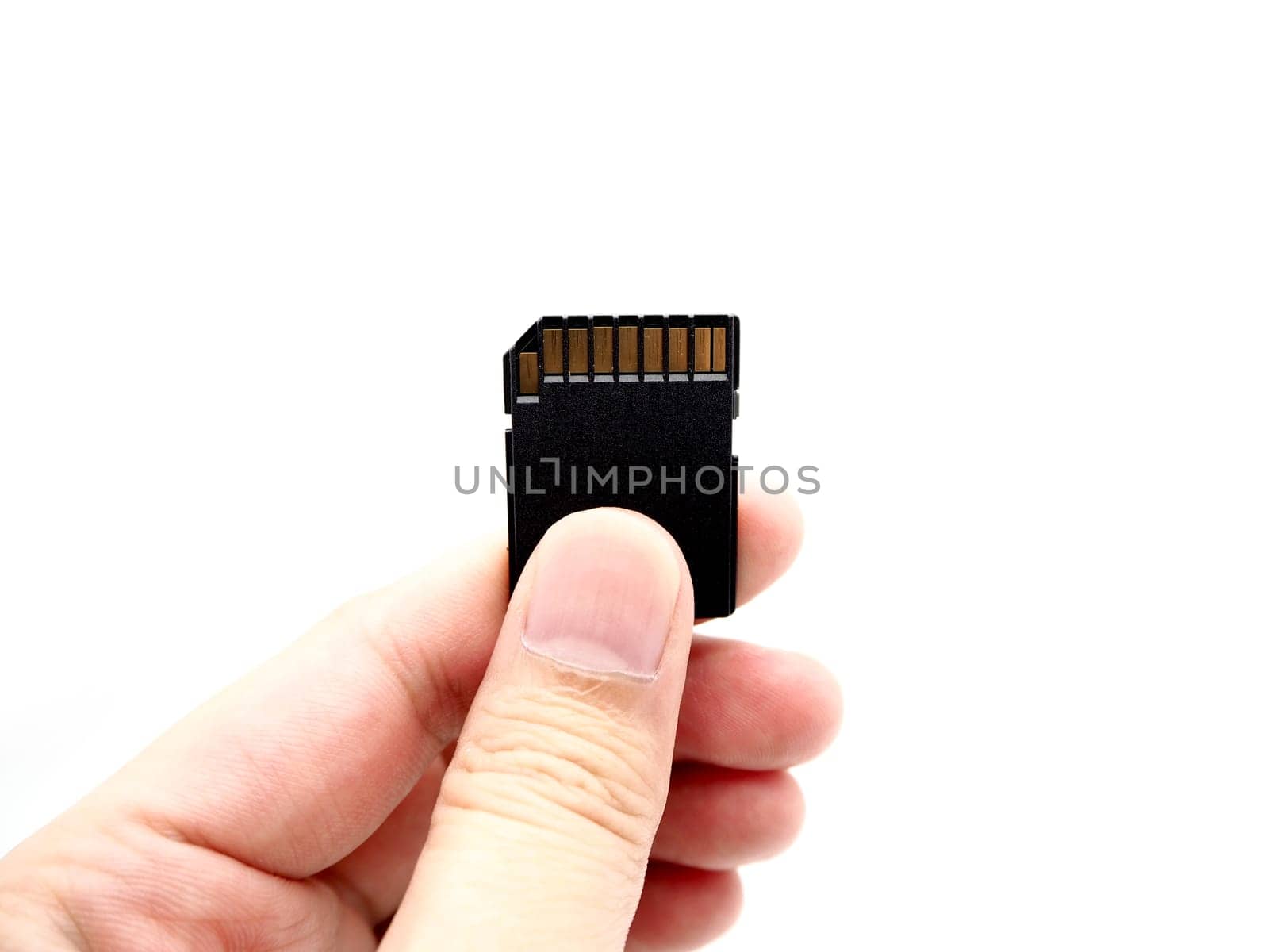 Hand holding a memory card isolated on white background.