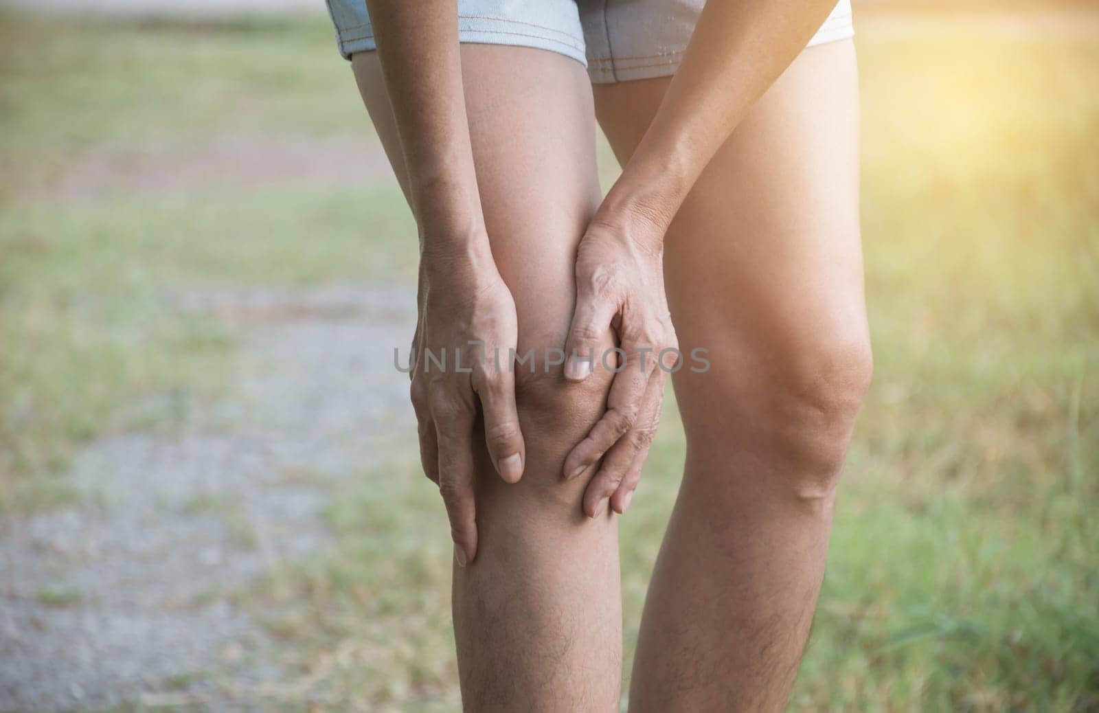 The female clings to a bad leg. The pain in her leg. Healthcare and painful concept.