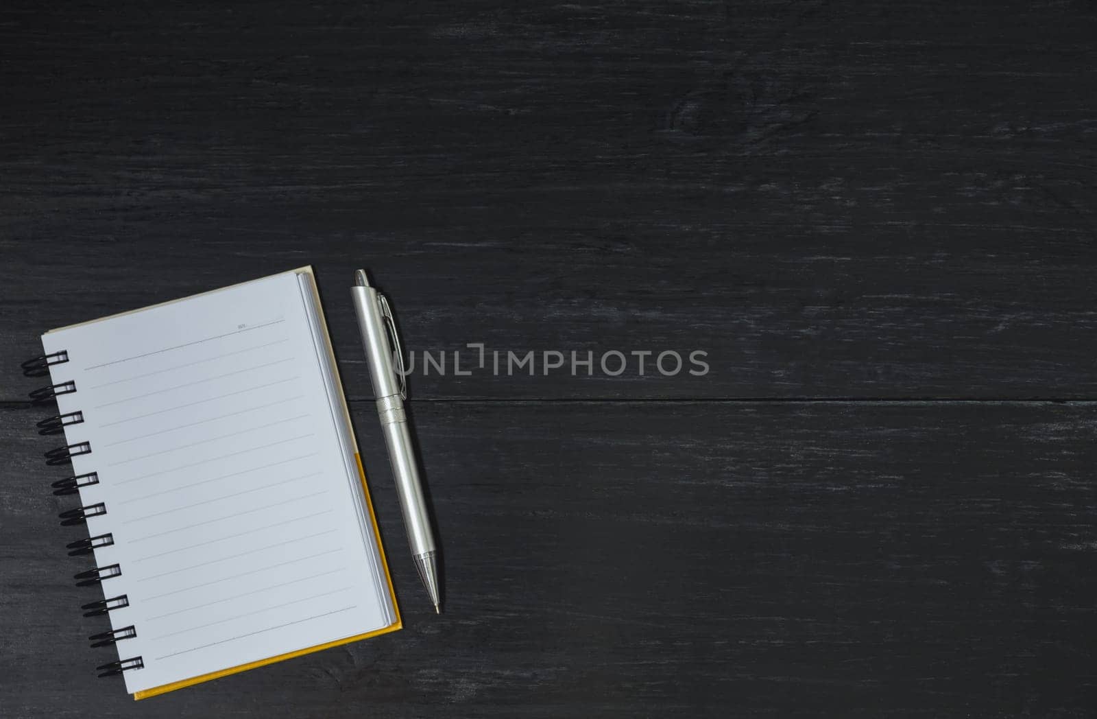 Top view of open book. Book open with pen on wooden background and copy space for insert text.