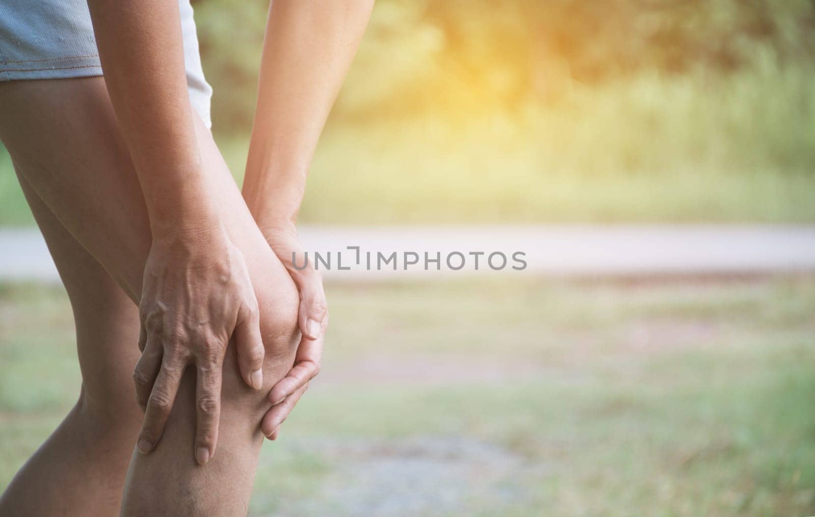 The female clings to a bad leg. The pain in her leg. Healthcare and painful concept.