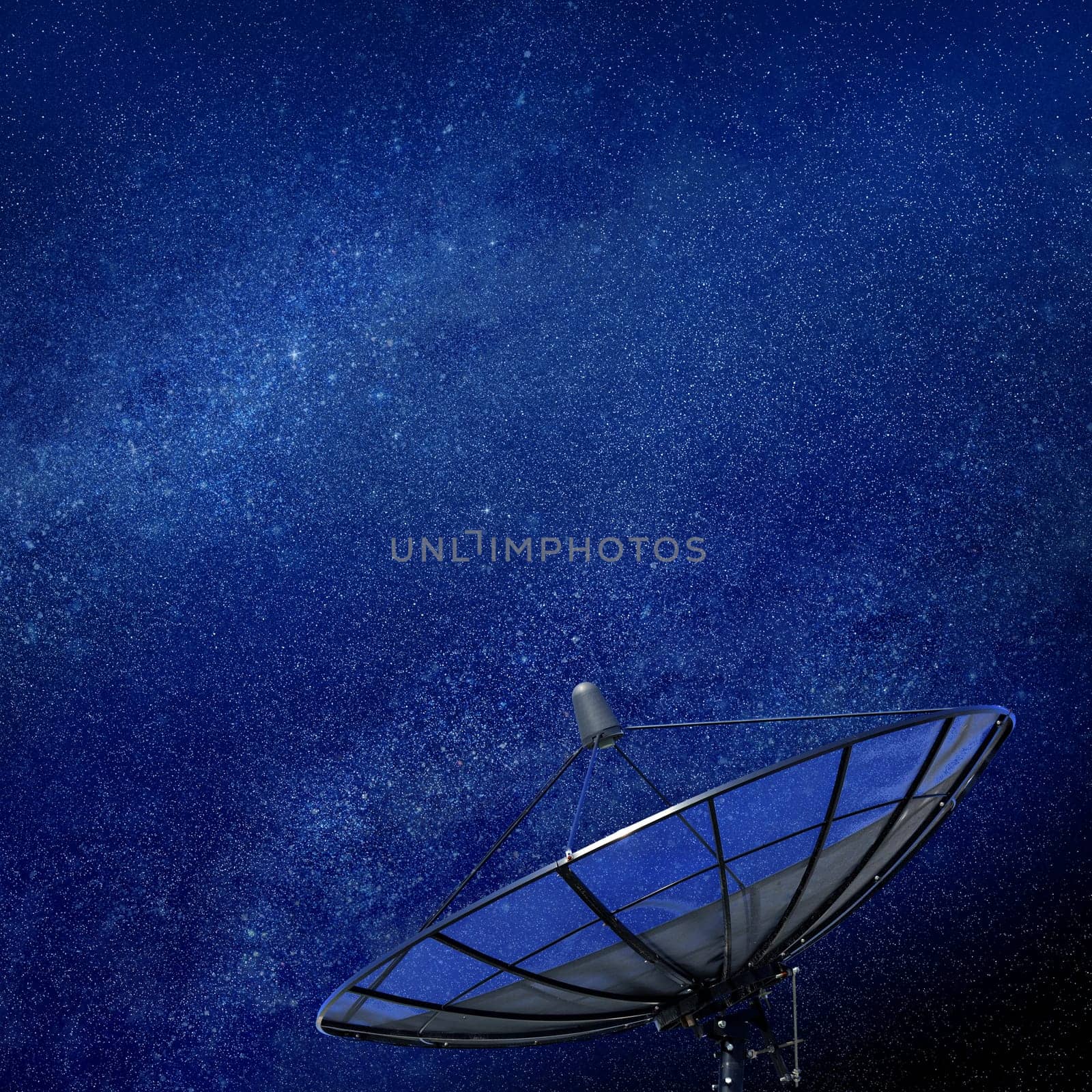 Conceptual image of a satellite dish antenna over night sky with stars of galaxy