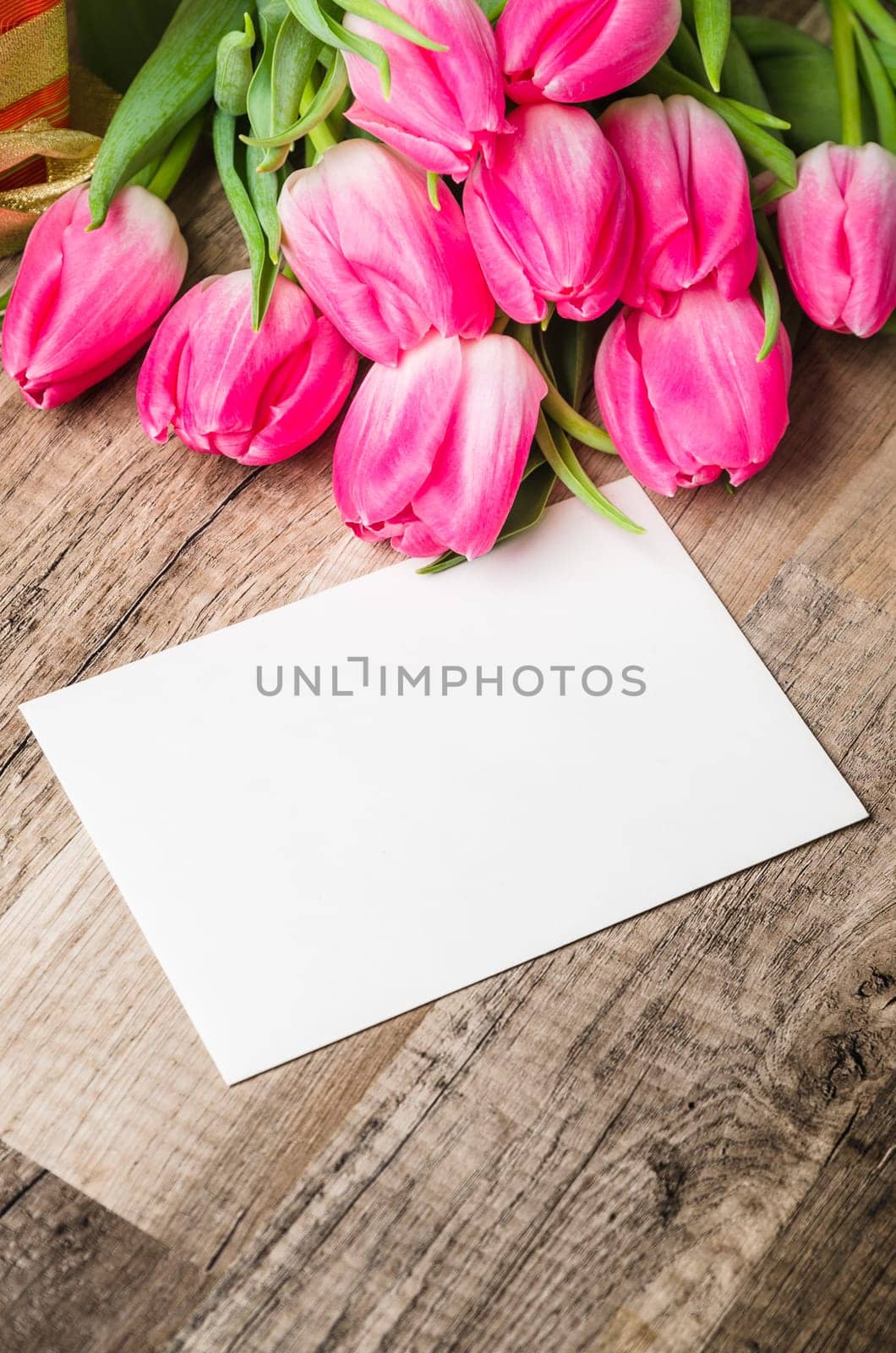 Beautiful bouquet of pink tulips and congratulations on the table