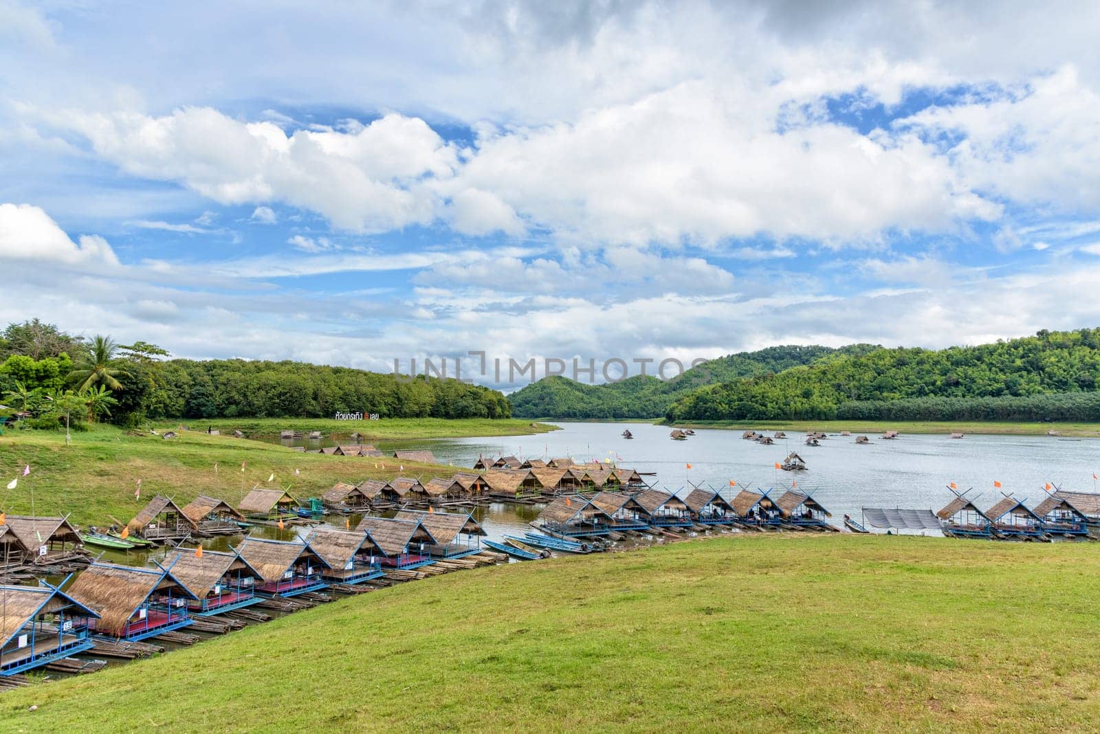 Bamboo raft shelter are floating restaurant in the middle of water under the blue sky as a tourist attraction at Huai Krathing Reservoir, Loei province, Thailand