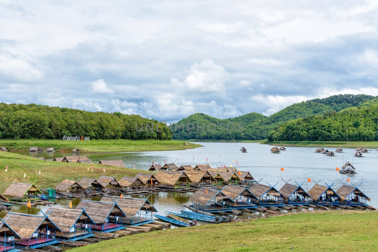 Bamboo raft shelter are floating restaurant in the middle of water under the blue sky as a tourist attraction at Huai Krathing Reservoir, Loei province, Thailand