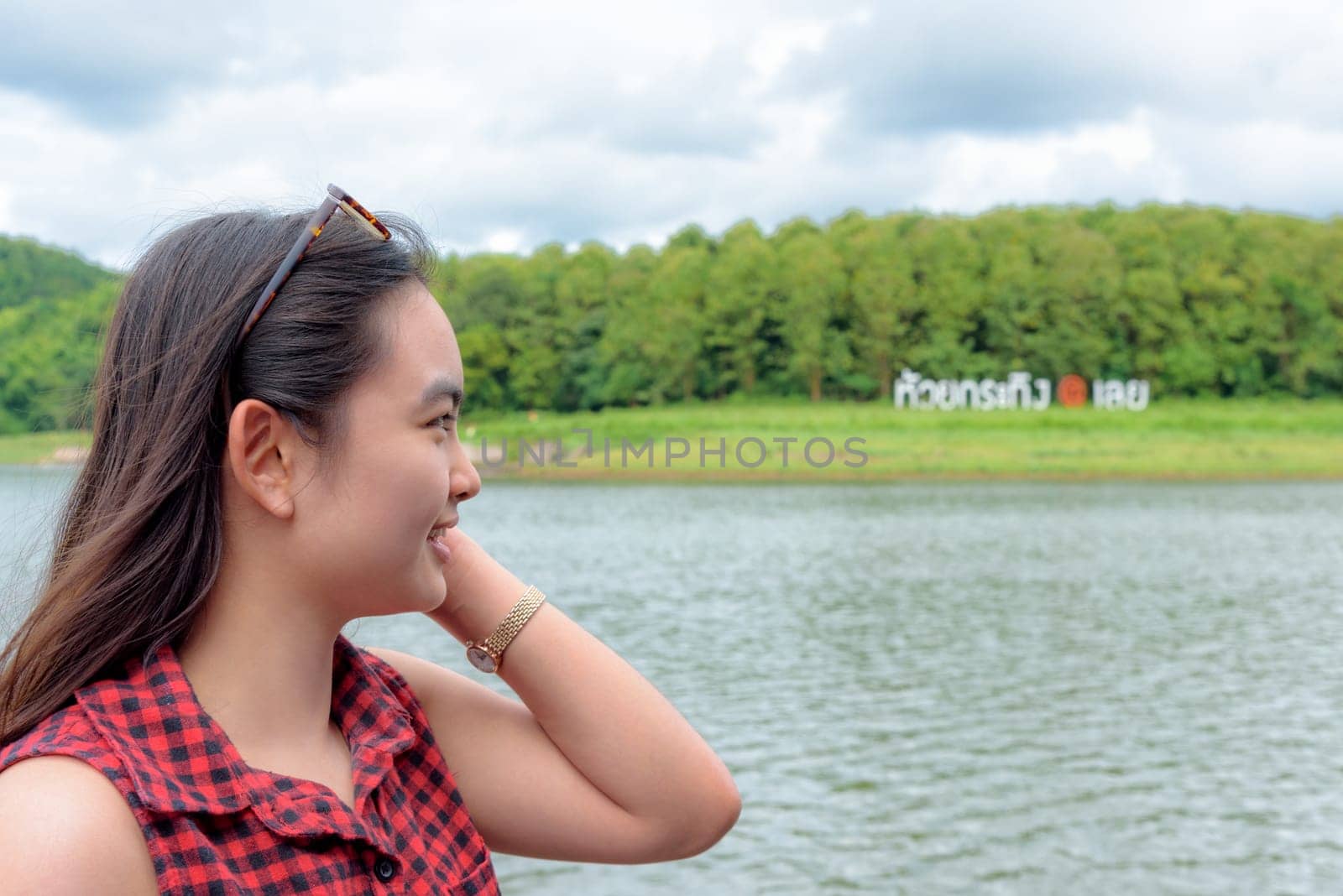 woman tourist are watching the nature of river, forest and mountain at Huai Krathing Reservoir is a tourist attraction of Loei province, Thailand